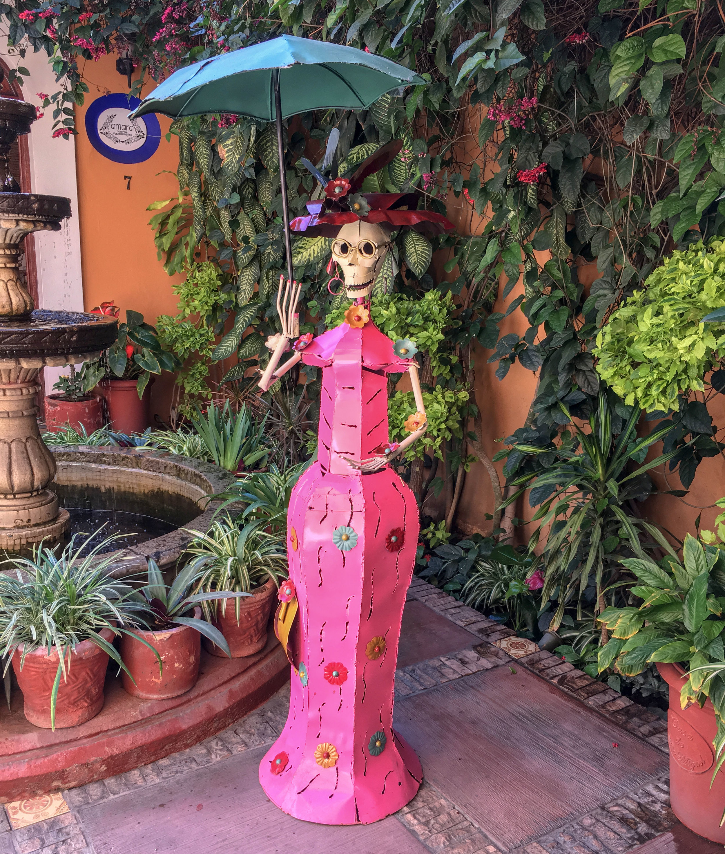 Female figure in painted sheet metal, life-size.