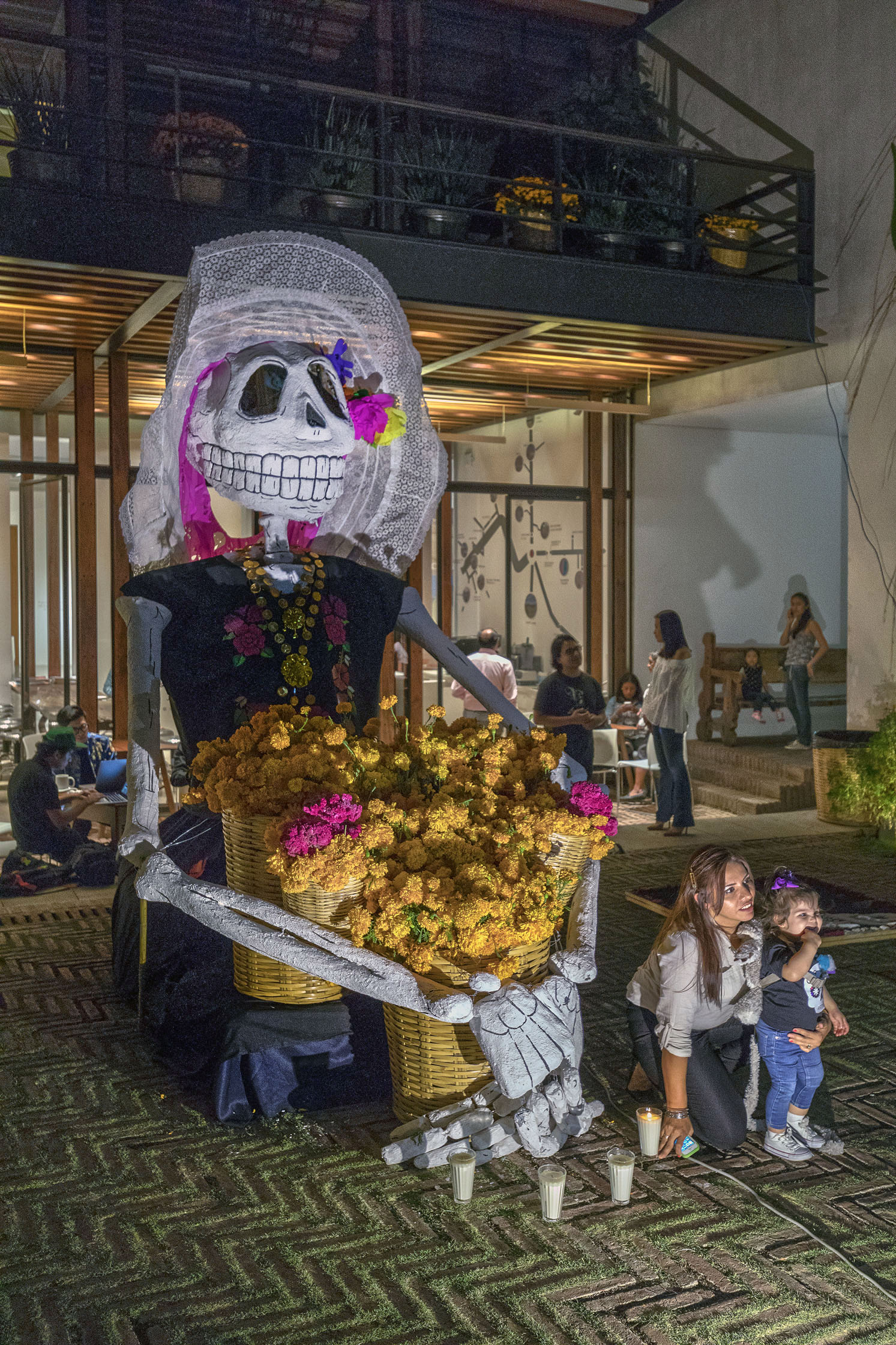 Large scale La Calavera Catrina in museum courtyard.