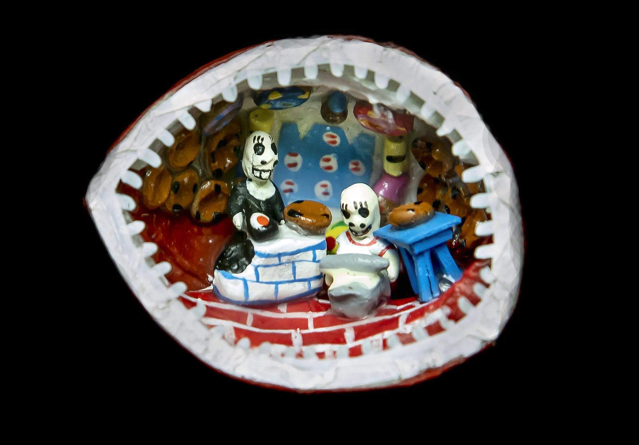 Calaveras baking Pan de Muertos, miniature inside a walnut, 6.9 cm on width.