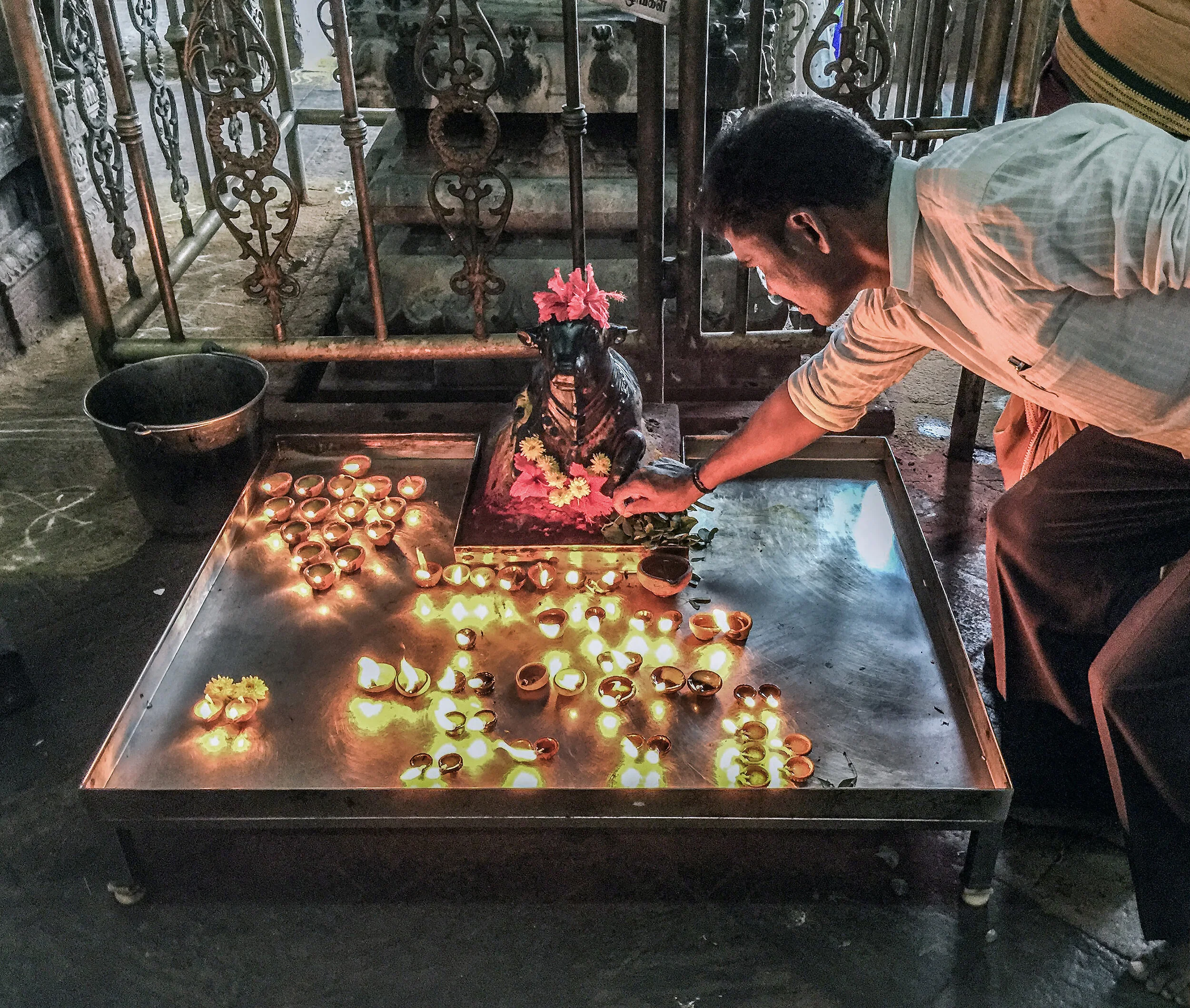  Each temple devoted to Shiva has a shrine with a votive figure of Nandi the bull. Hindus worship the shrine by saying the word  Hara, Hara  into the figure's ear. Hara is one of the names of Shiva, meaning the destroyer (of sins). Leaves of the bael