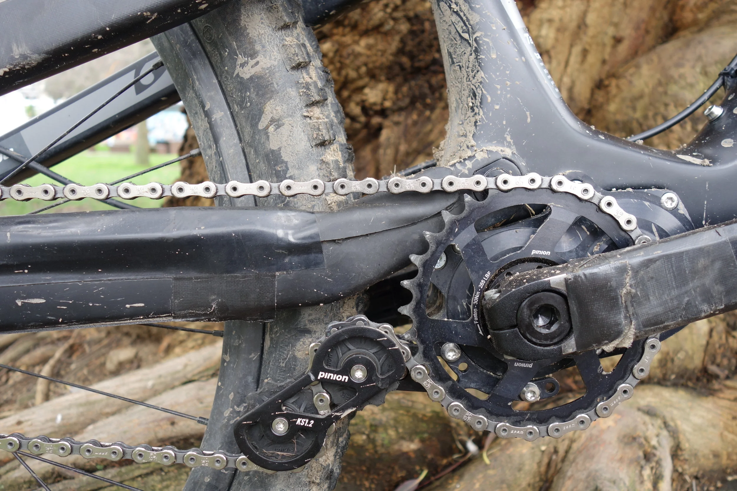 Dont pay any attention to the stealth tape. That's Ali trying to keep his bike looking as good as possible while waiting for his invisiframe clear tape kit. As it's basically a single speed design a tensioner is needed to take up the slack. Cranks and front ring are both part of the Pinion package. When you back pedal the chain and cog don't rotate. You can change gear just sitting there eating your sandwich.