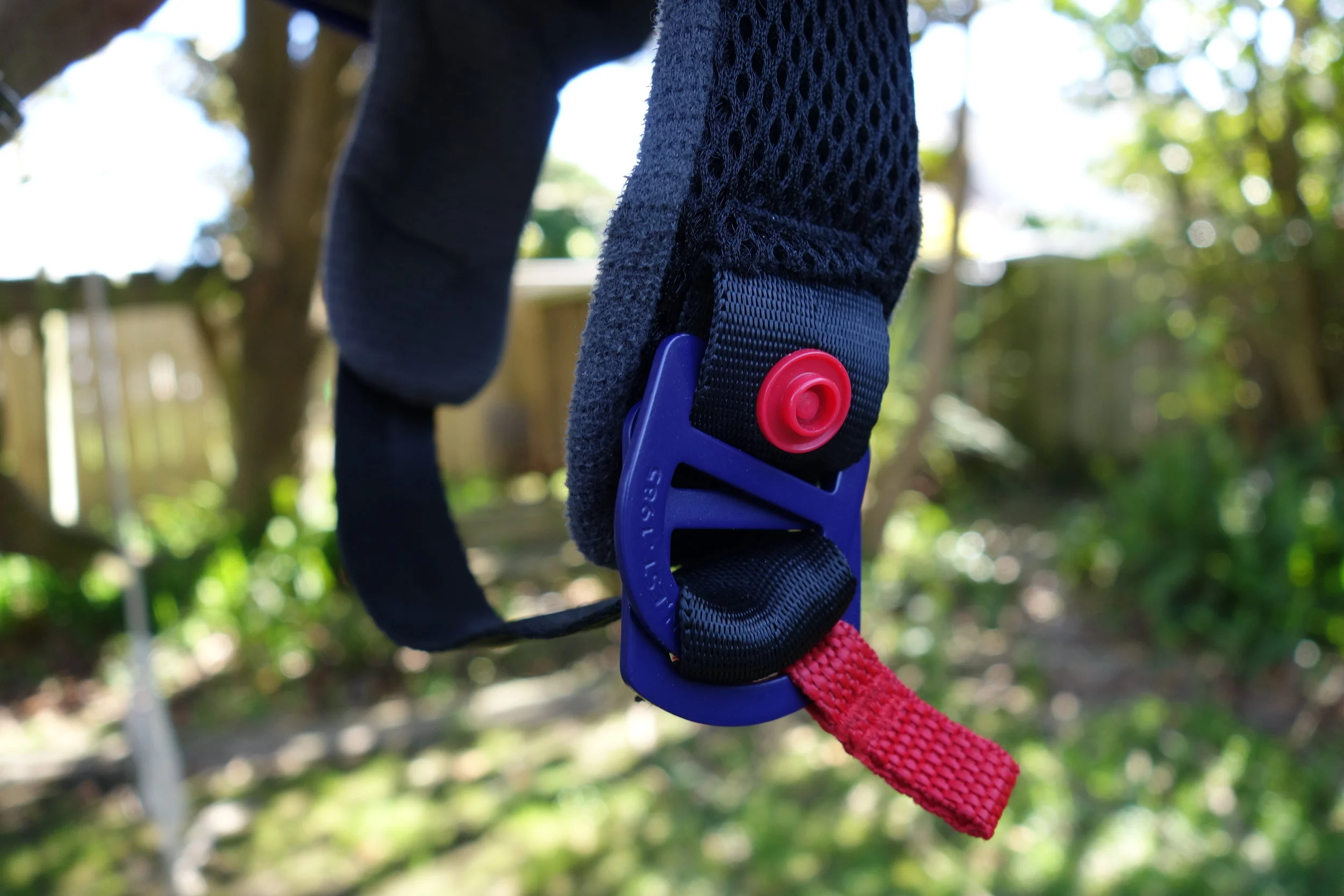 D-loop buckles. They can be quite fiddly and take a bit of getting used to. It's old technology from back when plastic buckles weren't invented. But they work and are fail proof. The harder you pull the stronger it holds. A hard impact could possibly pop open or snap the standard buckle we are used to seeing on our XC lids.