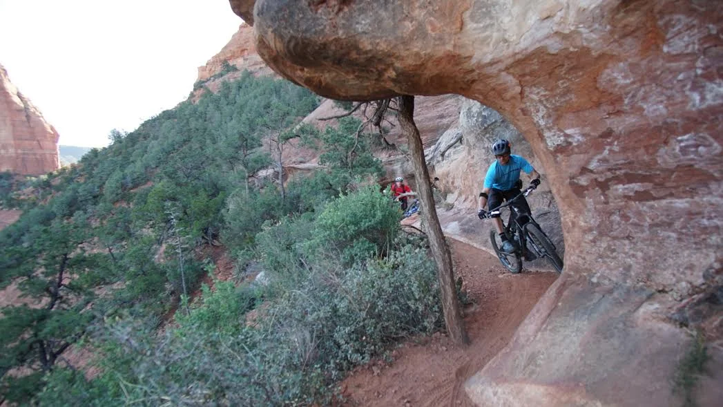 This part of Hangover trail was a dirt ledge sandwiched in a steep slickrock face. It was super techy with roots and rocks waiting to clip your pedals and rock overhangs waiting for wide bars to graze through. photo: Jeff carter