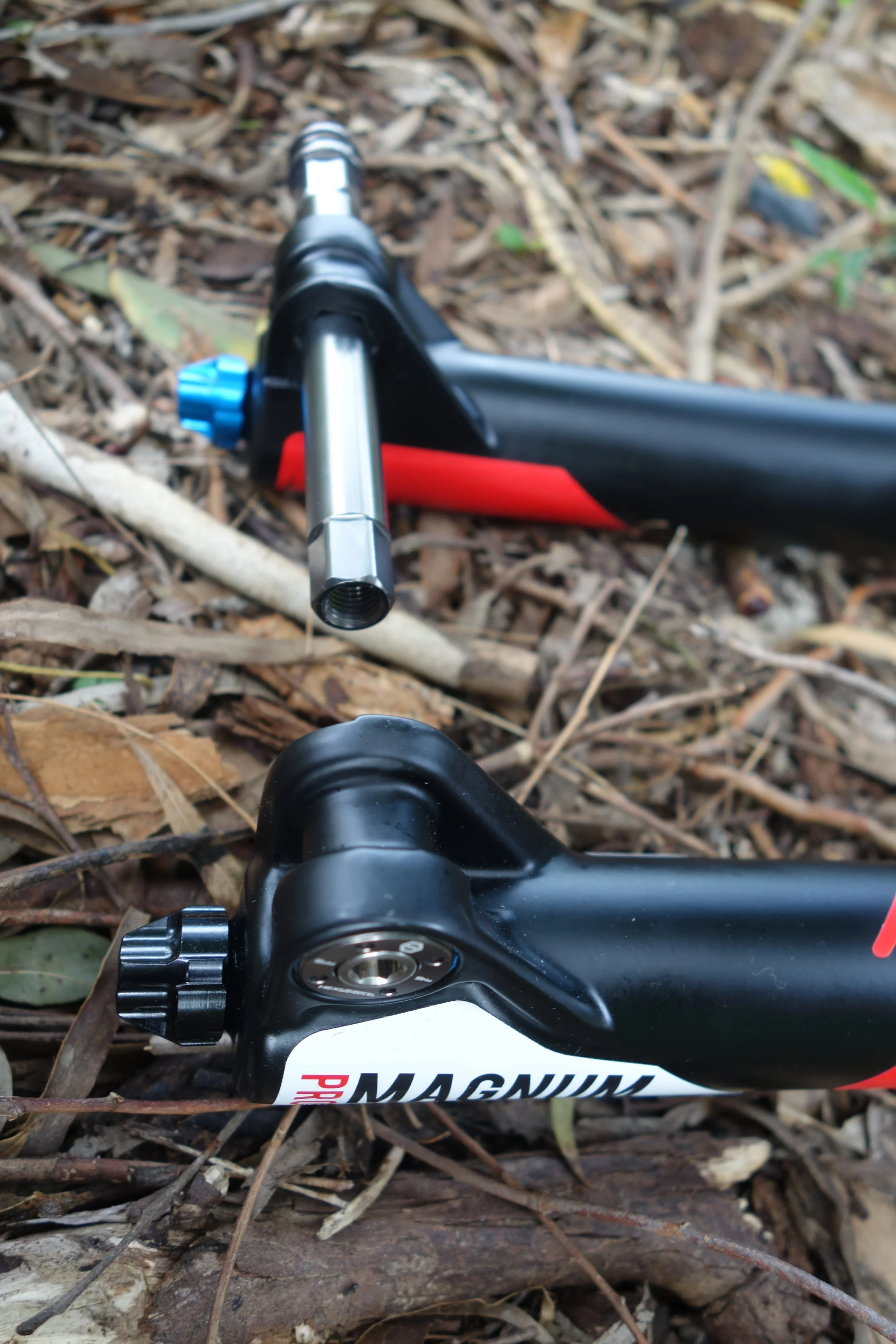 The axle has a hex shape at the end to lock into the lowers and prevent torsion flex.The axle head stays in the fork, so you can't lose it. Rebound knob in the usual place.