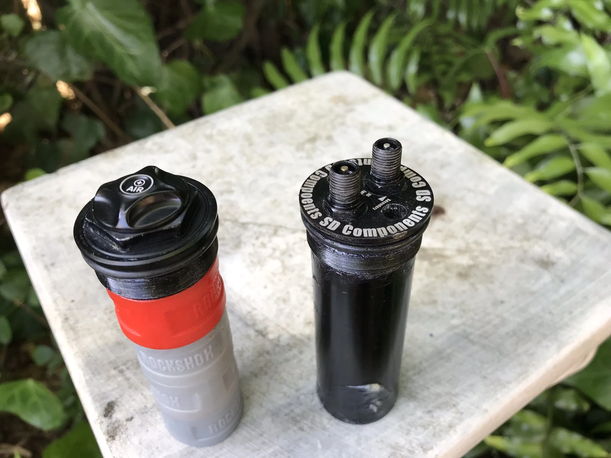 My stock air cap on left with 4 volume spacers to show the similar size to the DVC on right
