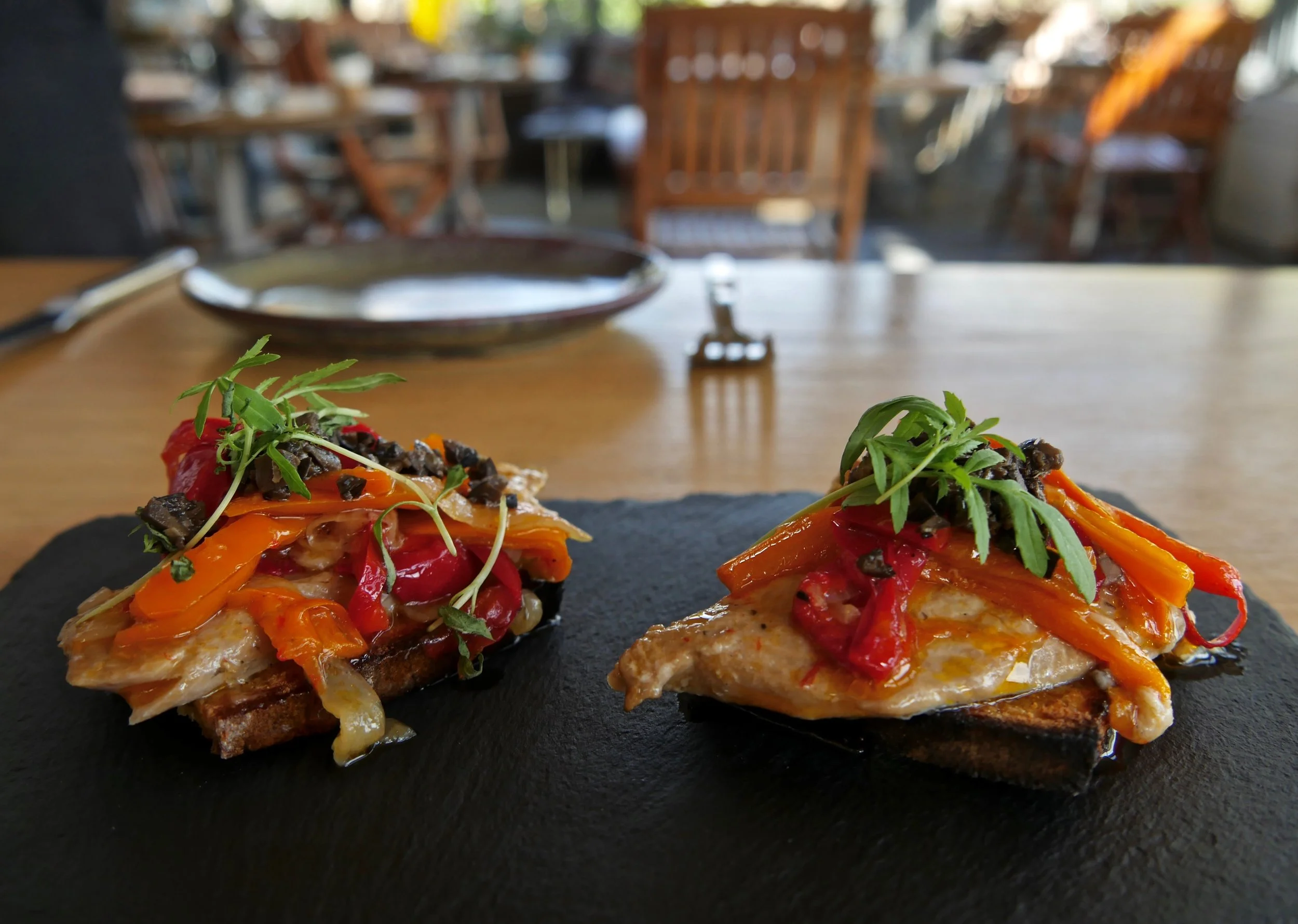 Marinated trout with roasted peppers on corn bread toasts.