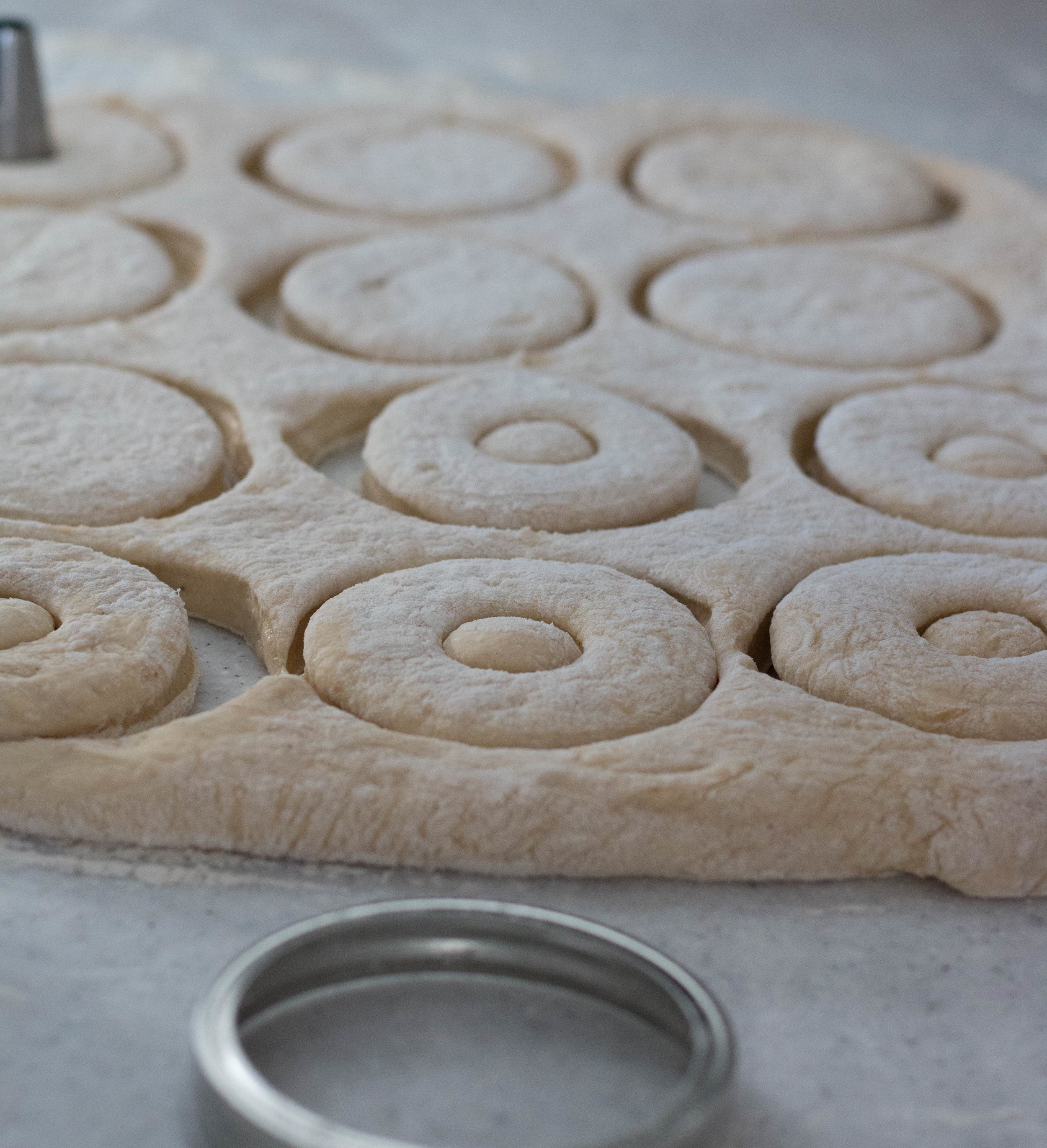 We were scrambling for a biscuit cutter of some sorts to punch the donuts and we settled for the top ring of a large mason jar lid. It worked PERFECTLY!