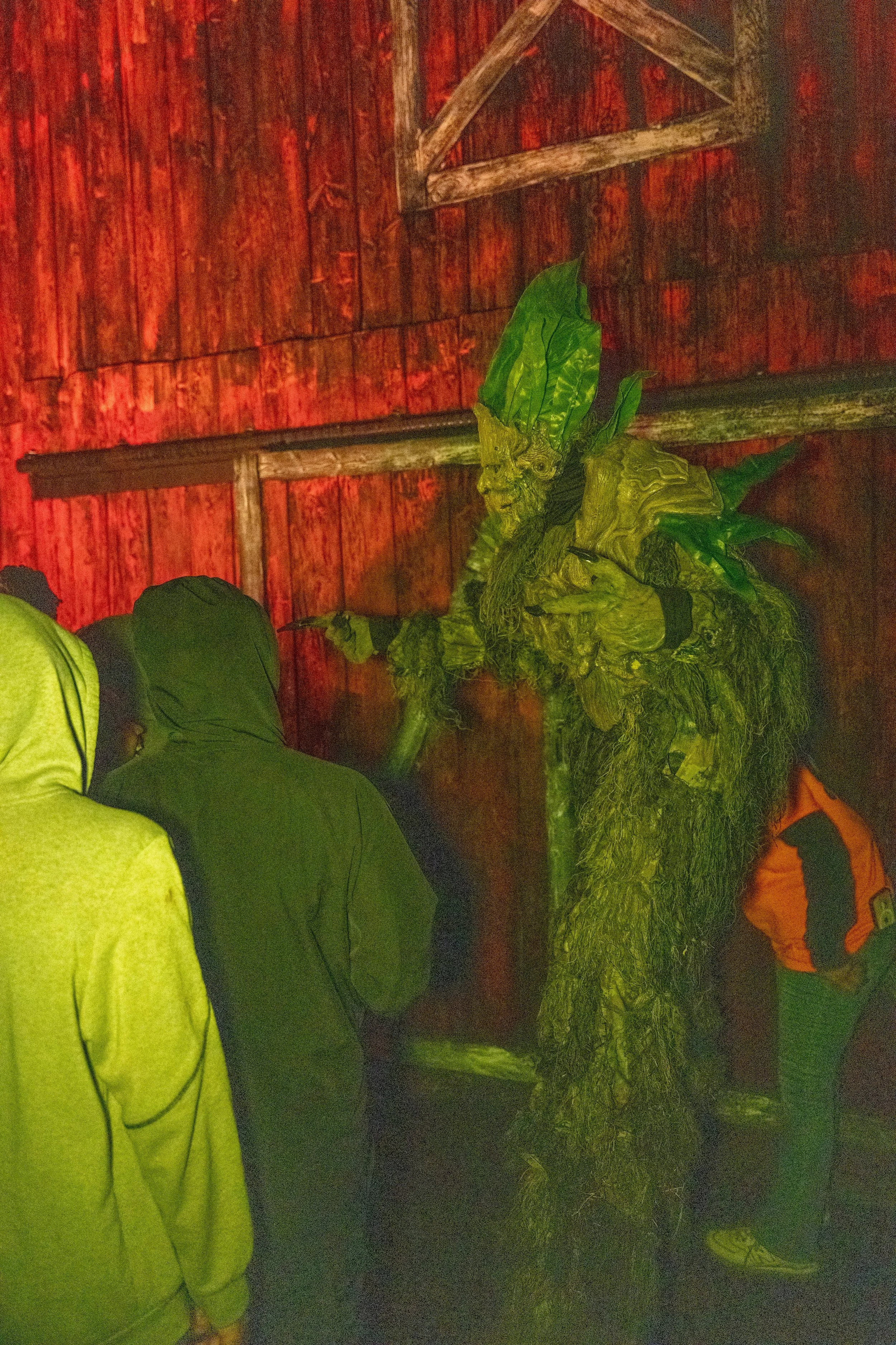 An imposing corn monster, lurking over customers attempting to enter Cornstalkers.