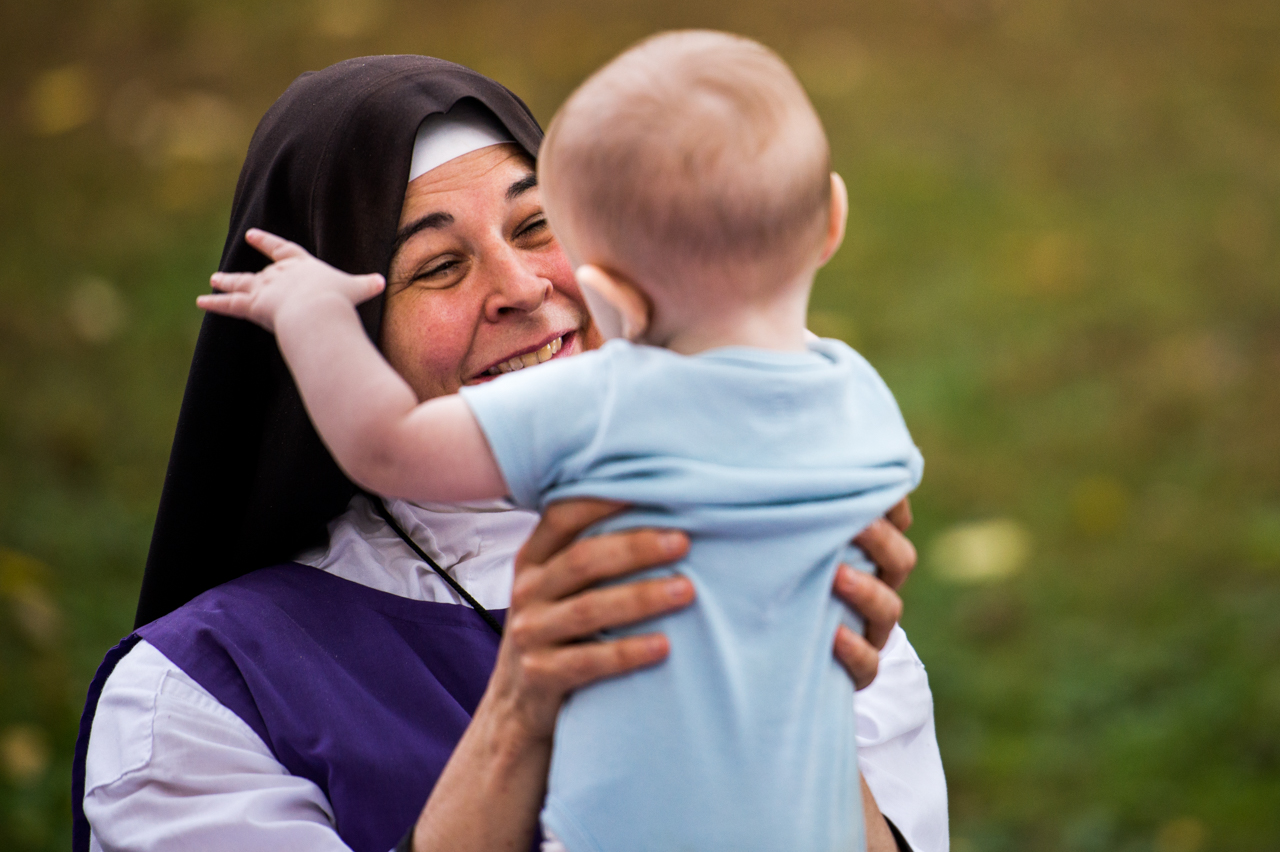 Sister Joseph Marie, who joined Children of Mary in 2013, entertaining Jude (last name withheld), 1, during community dinner at Children of Mary in Newark, Ohio, on September 24, 2016. Jude and his family live on the land with the sisters and