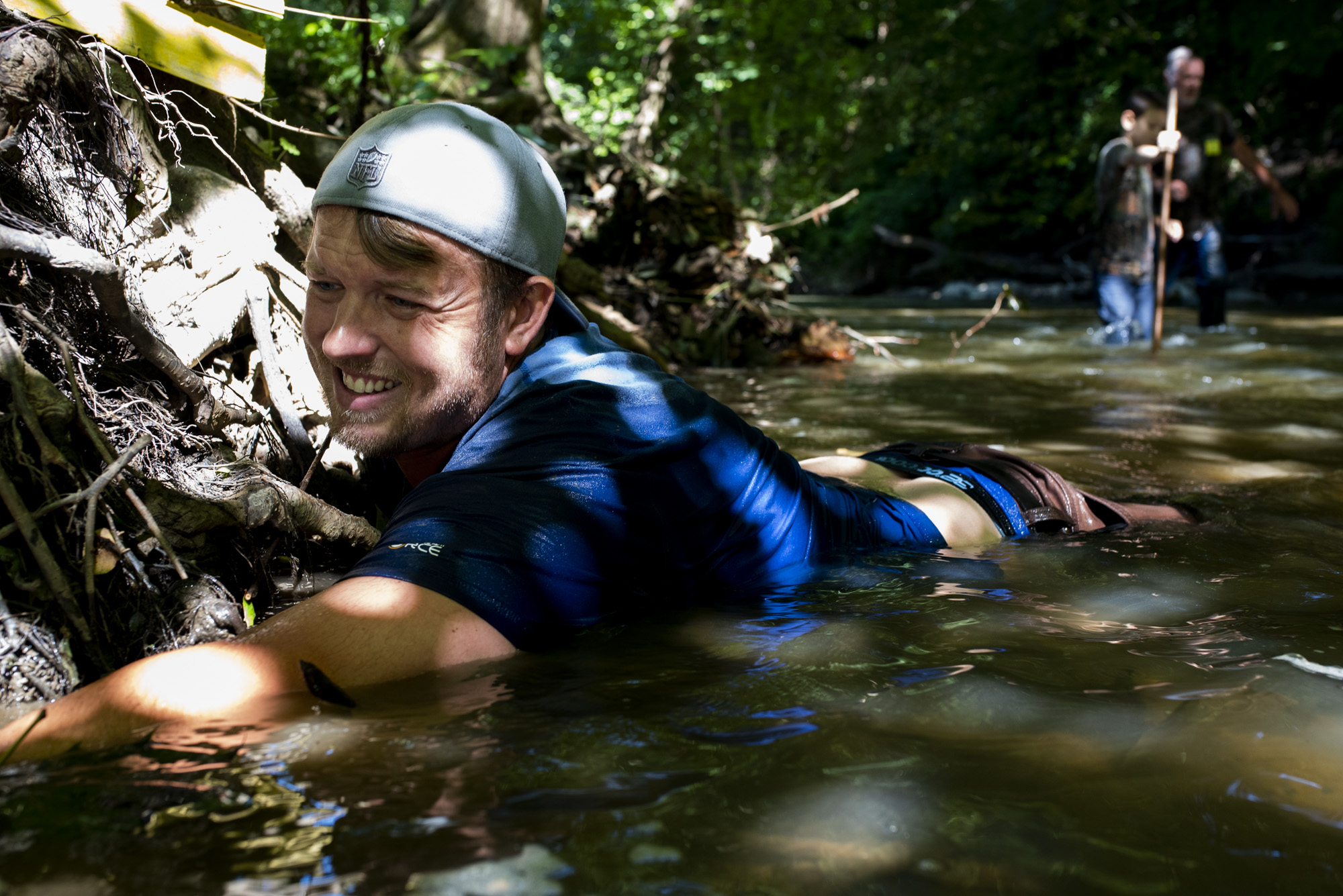  Joey Clemens , of Murrysville, reaches into a hole under tree roots as he hunts for snapping turtles. 