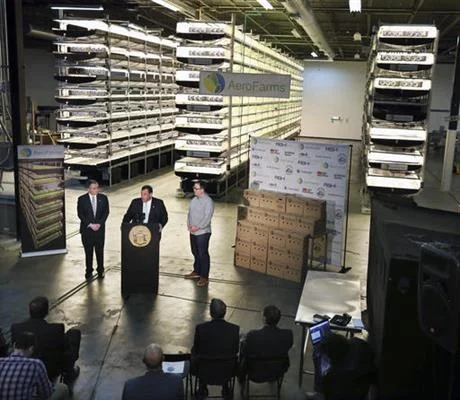 On this Thursday, March 24, 2016, file photograph, New Jersey Gov. Chris Christie, center at podium, addresses a gathering at AeroFarms, a vertical farming operation in Newark, N.J. AeroFarms is now refurbishing an old steel mill in New Jersey and they say it will soon be the site of the world's largest indoor vertical farm. The company says their Newark facility, set to open in September, could produce 2 million pounds of food per year and help with farming land loss and long-term food shortages. (AP Photo/Mel Evans, File)