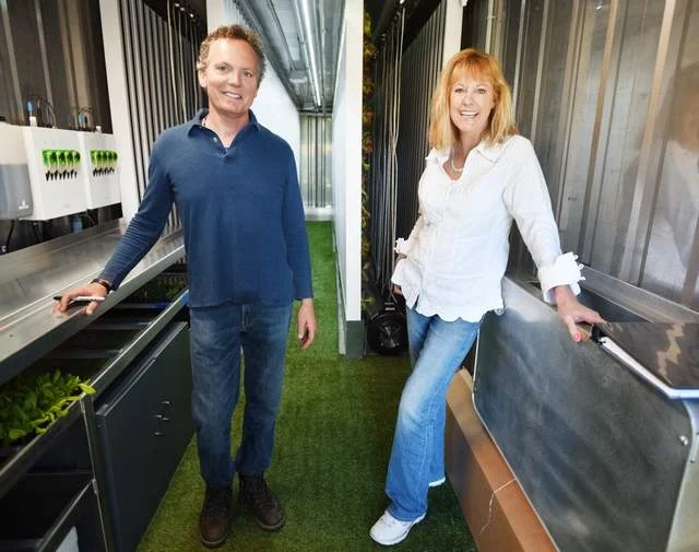  Wade Young and Pamela Marks in their freight farm on Monday, May 14, south of Woods Bay. The Leafy Green Machine is a fully assembled, vertical hydroponic farming system built inside a 40-ft. shipping container.(Brenda Ahearn/Daily Inter Lake) 