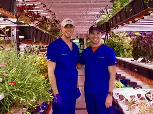 Fresh Impact Farm owner Ryan Pierce (left), and operations chief Matt McKinstry (right), stand in the 1,000-square-foot space in a suburban strip mall where they grow up to 60 varieties of edible flowers, herbs and greens at a time for restaurants.W…