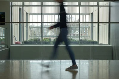 Ph A student walks past the new Green Roof vegetable garden at University Crossing. Ph oto by Ed Brennen