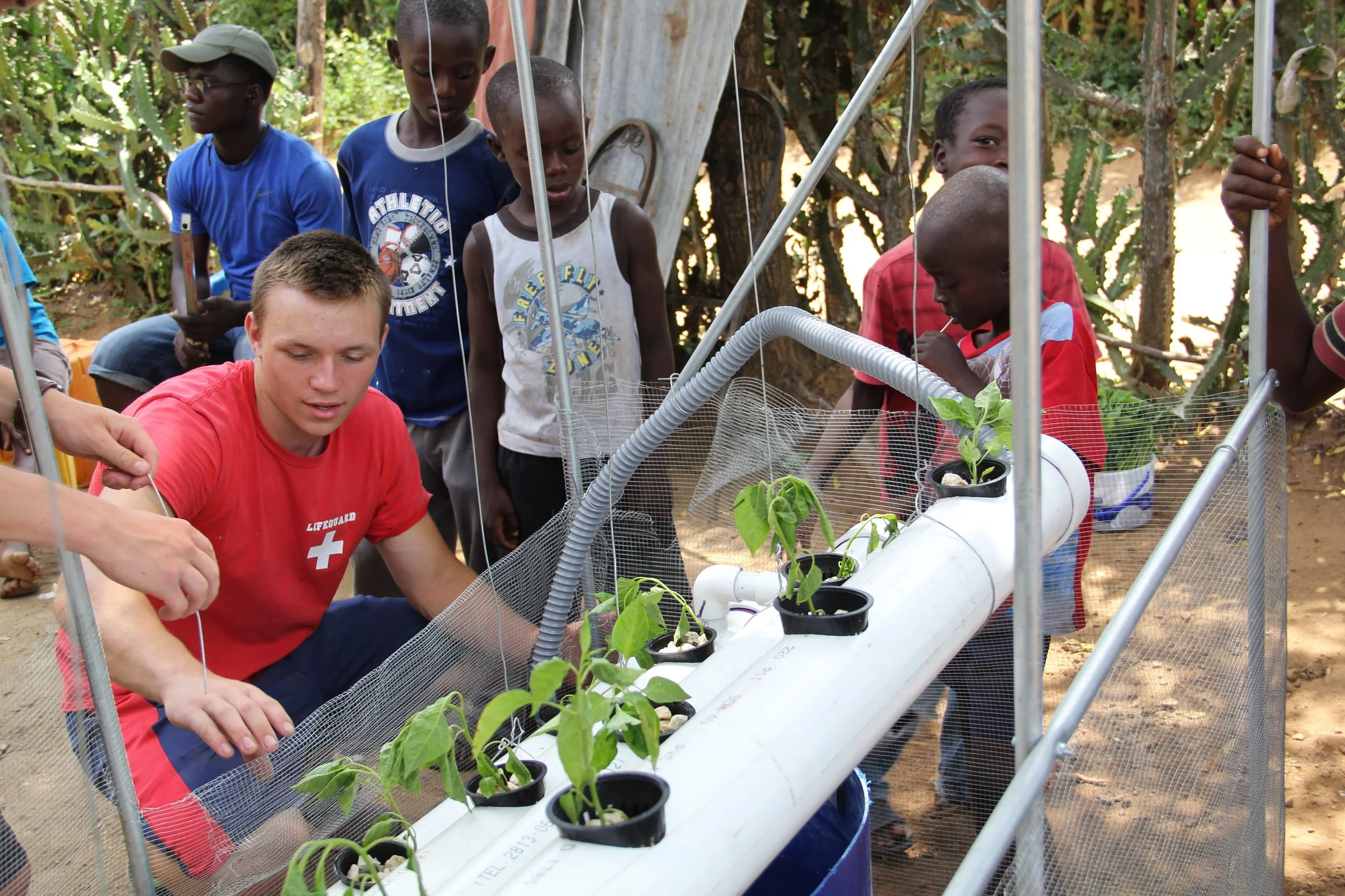 Christian Heiden ’20 (ENG), center, started a non-profit organization Levo International to bring hydroponics to those in need in Haiti.