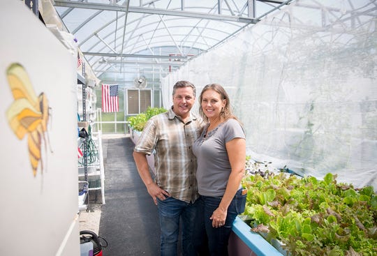 Glynn and Kellie Barber stand in a client's greenhouse in Daleville. (Photo: Jordan Kartholl/The Star Press)