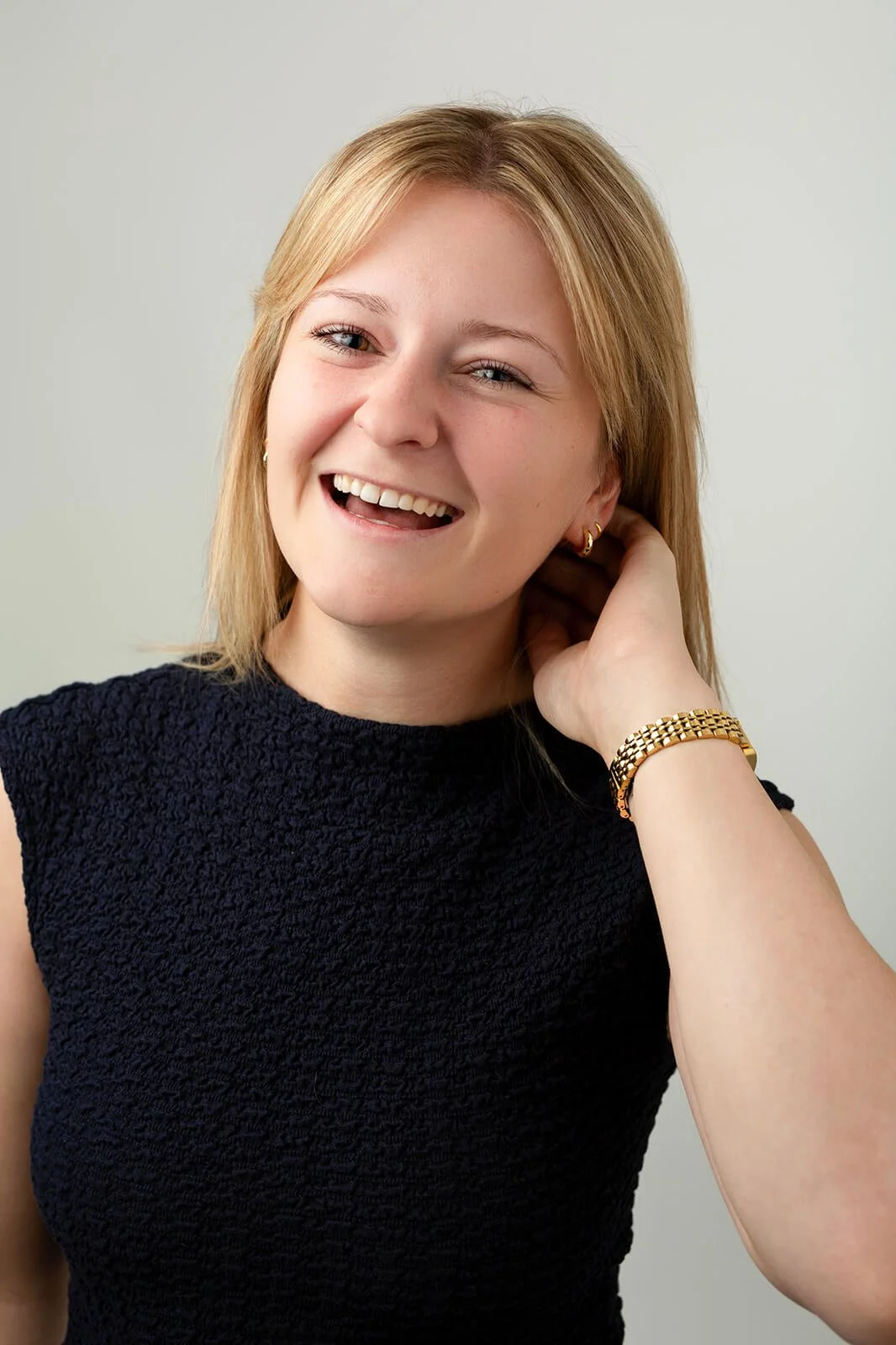 Natural, informal branding-style headshot of Rebecca during a professional photoshoot, ideal for social media and marketing content.