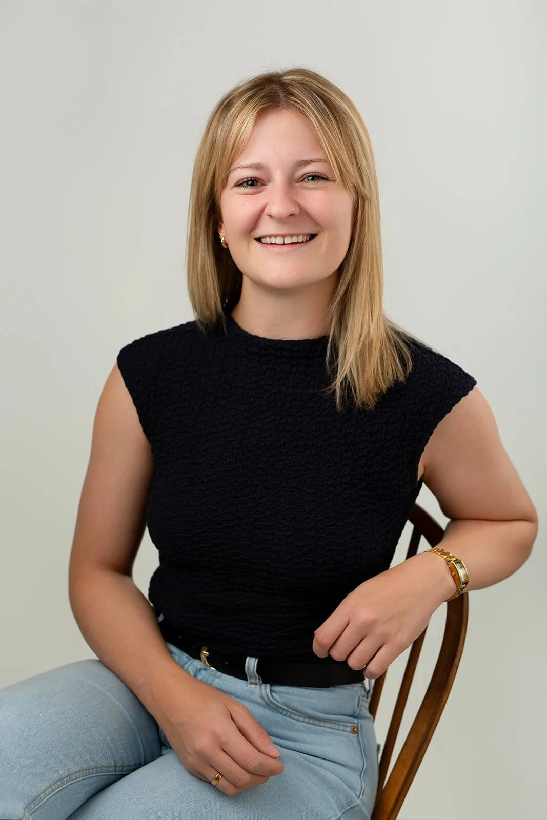 Professional headshot showing Rebecca smiling confidently at the camera