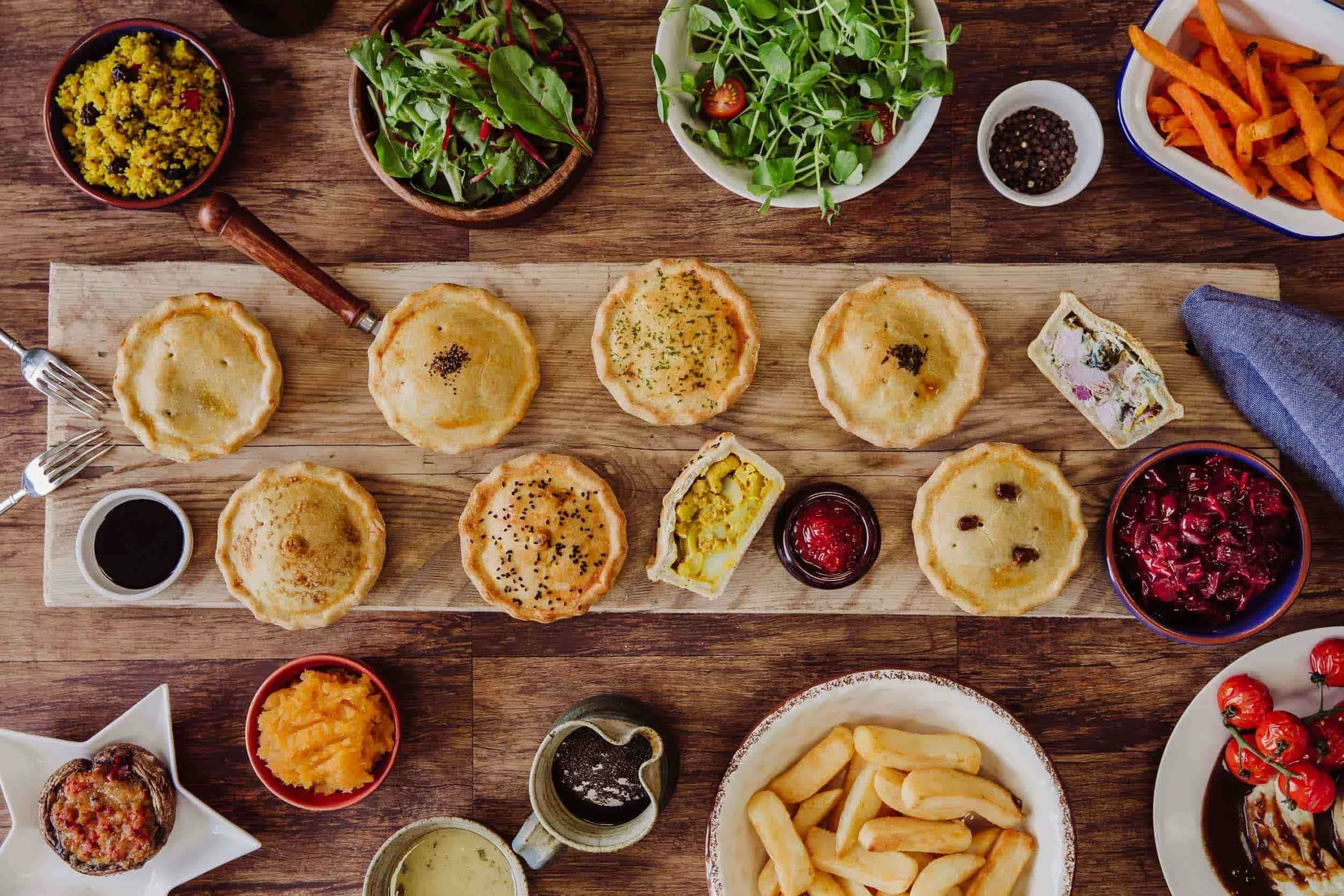 Flat lay product photography of pies with ingredients arranged around them