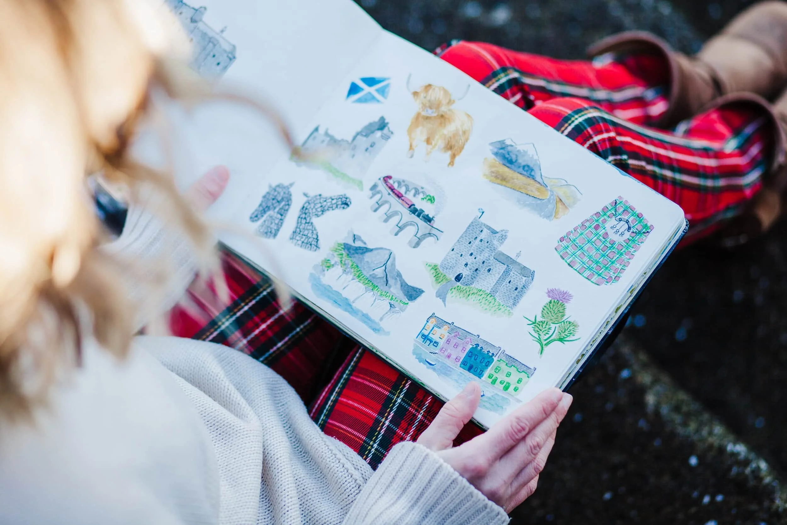 sketch book of scottish images on tartan trousers
