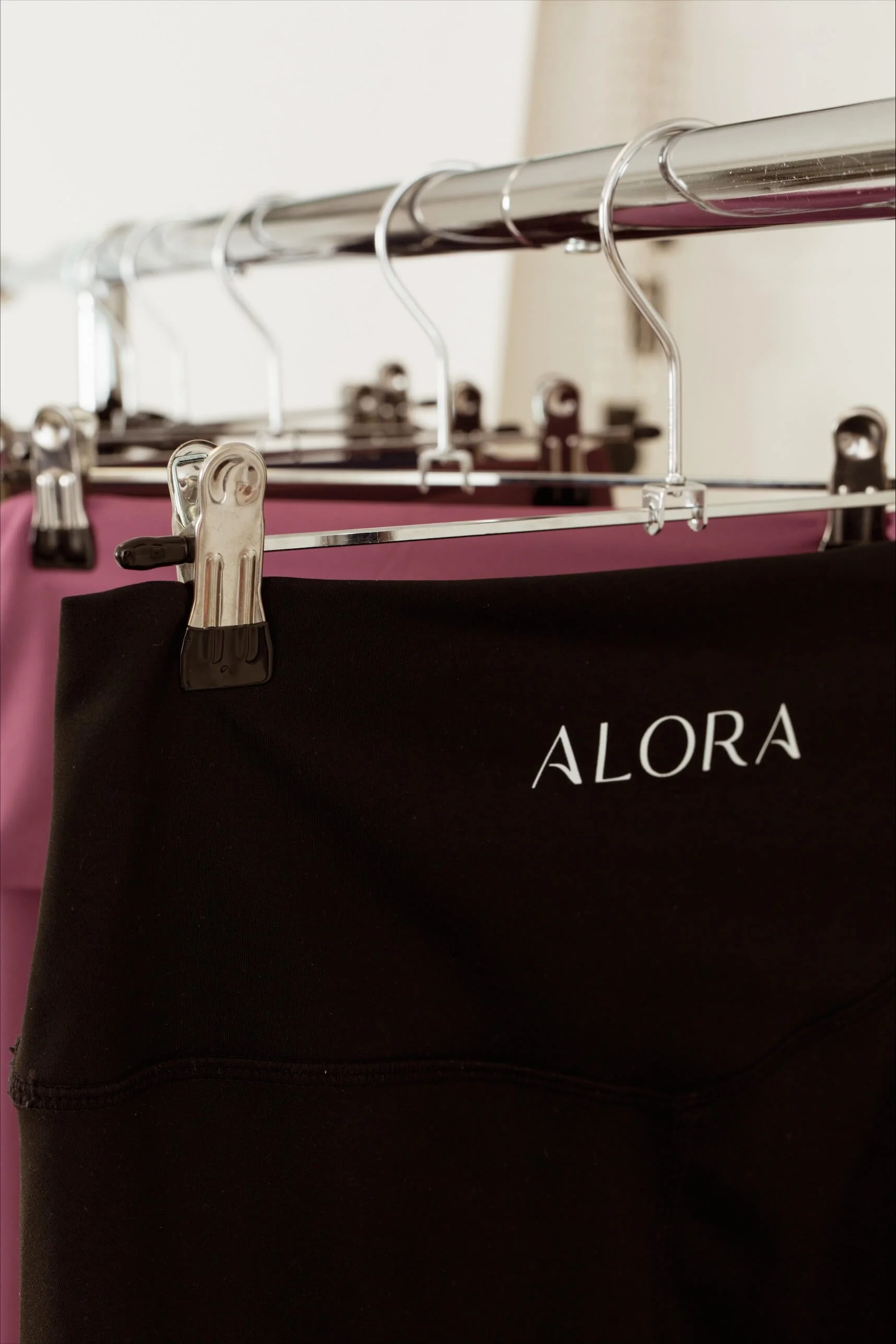 Gym leggings from Alora hanging on a rail in our studio for hire
