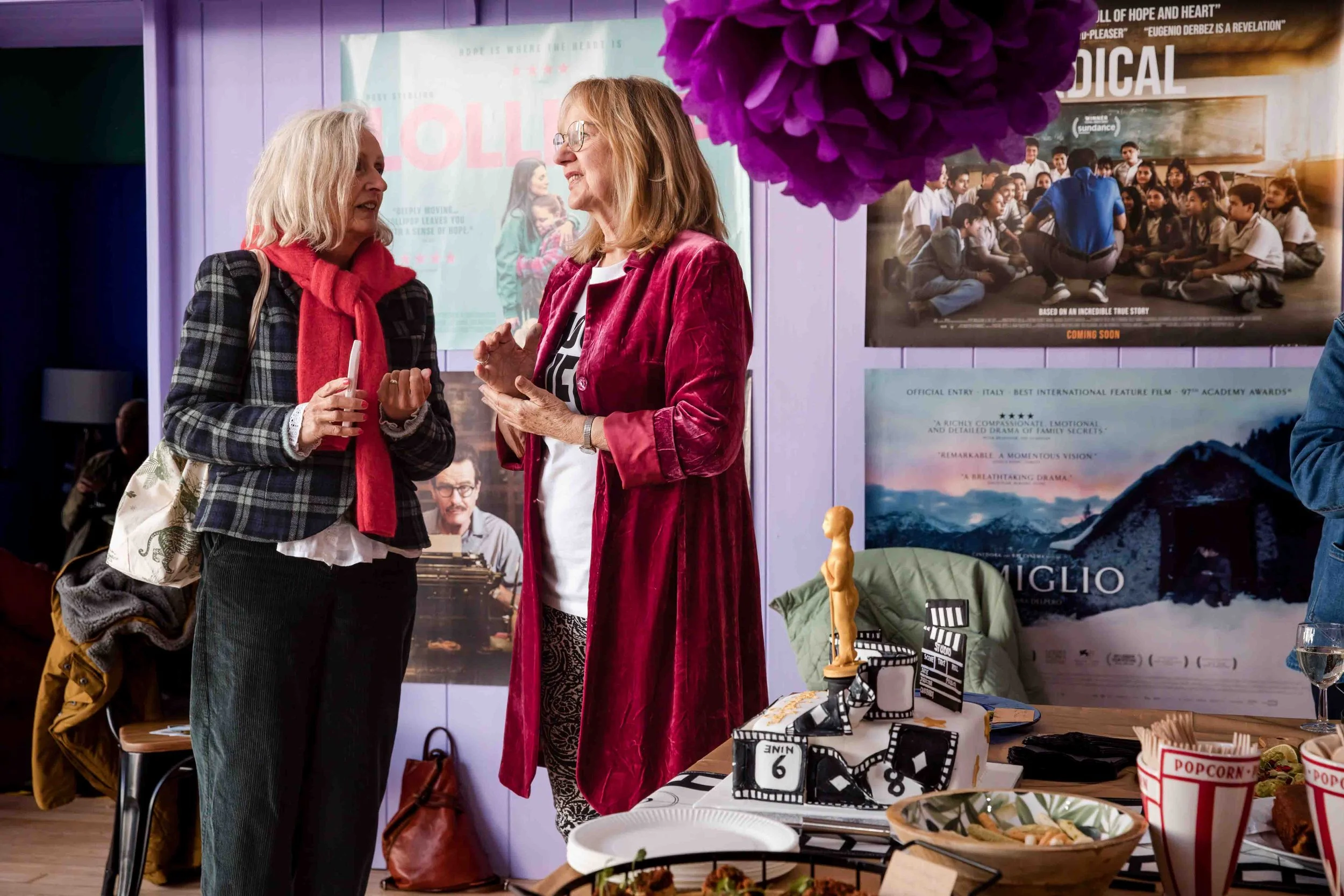 Guests chatting beside a film-themed birthday cake at Berwick Film Society’s 21st birthday celebration at Jackal.