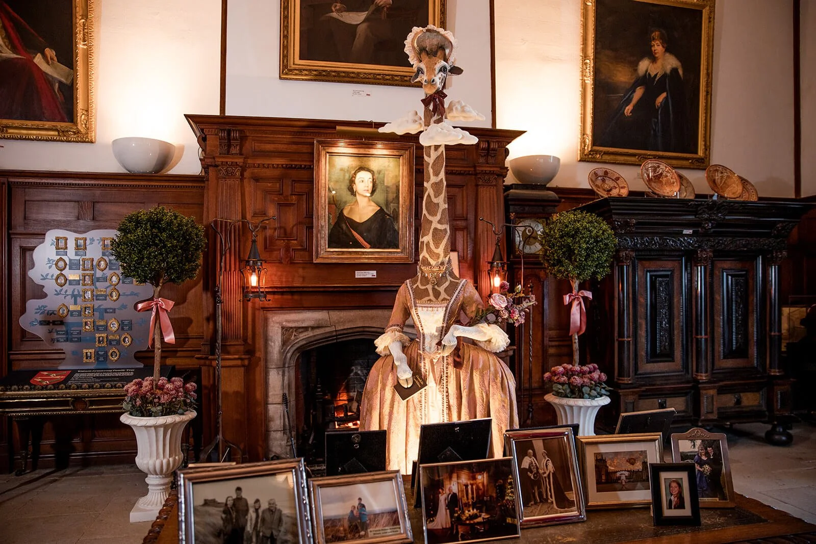 A almost life-size Sculpture of a giraffe showing the Idiom Head in The Clouds Mde by Mandy Bryson and displayed at Bamburgh Castle.