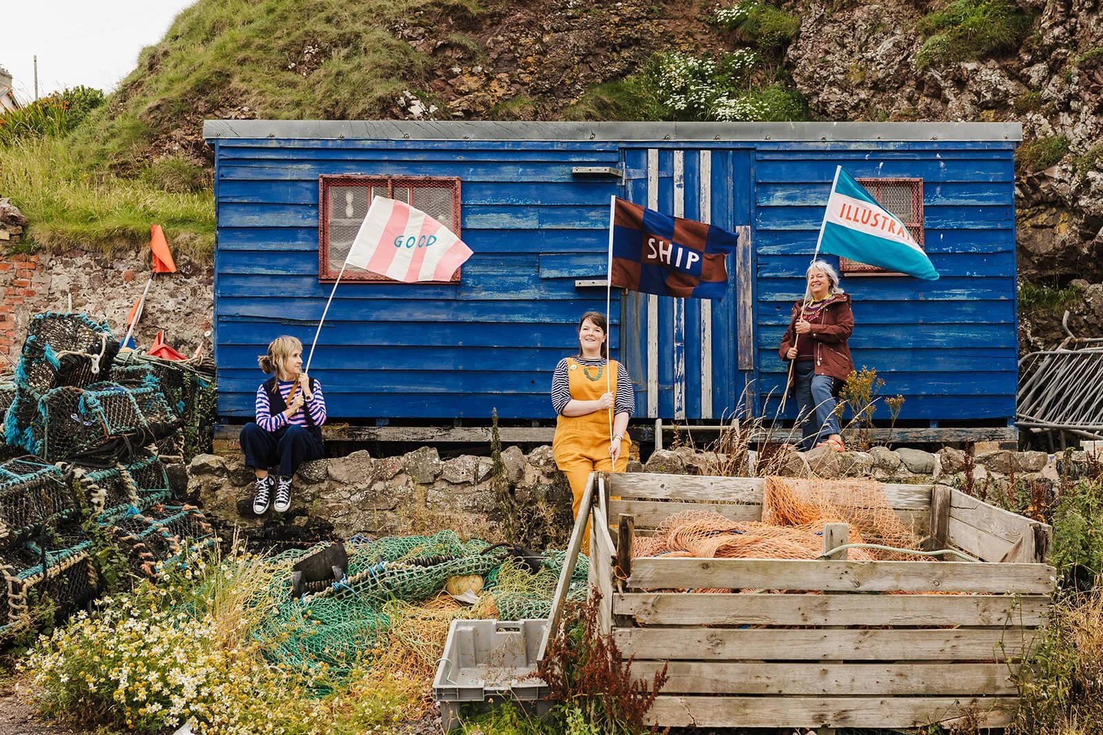 Brand photography for creative businesses featuring handmade nautical flags by the sea