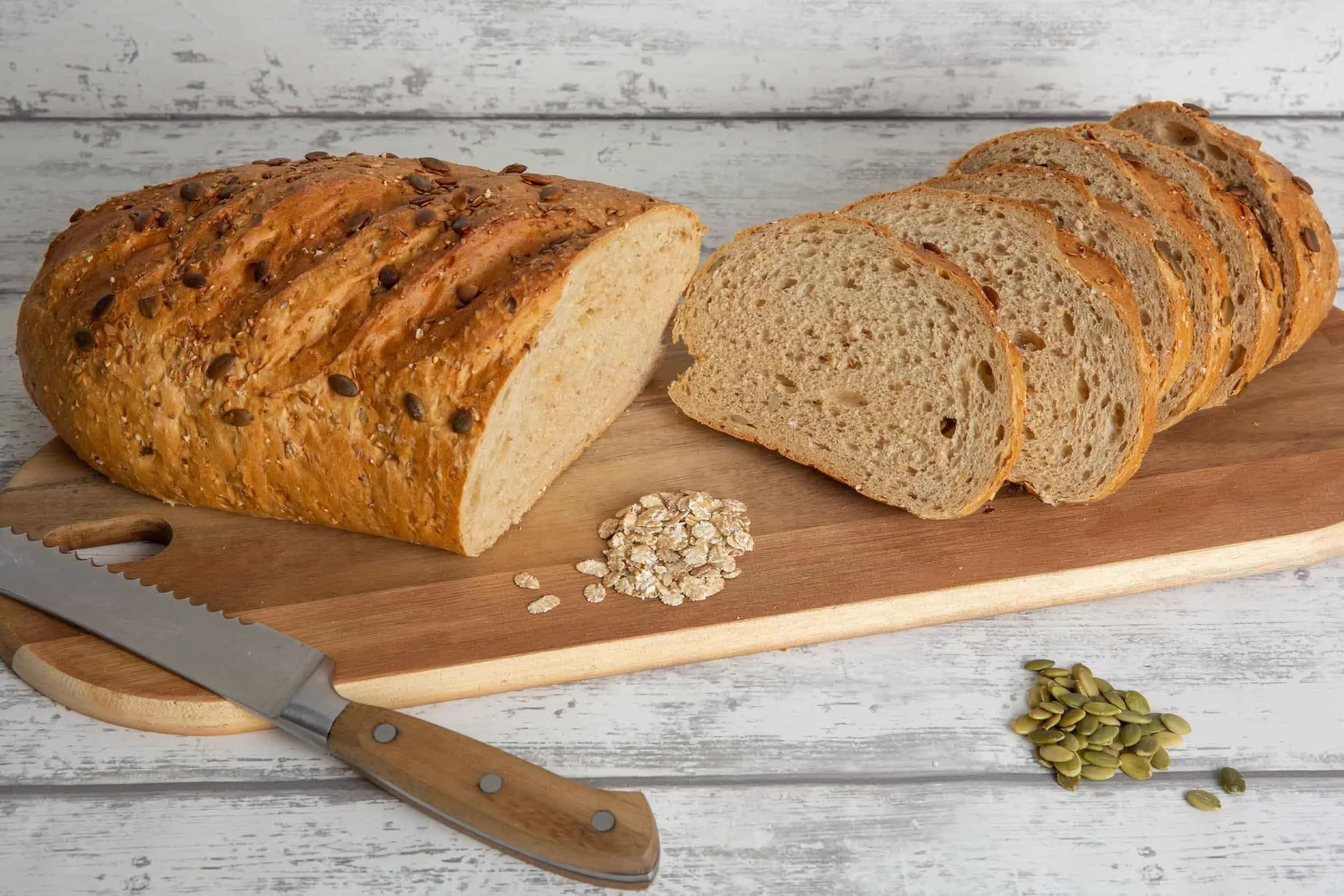 Product photography of freshly sliced artisan bread on a wooden board