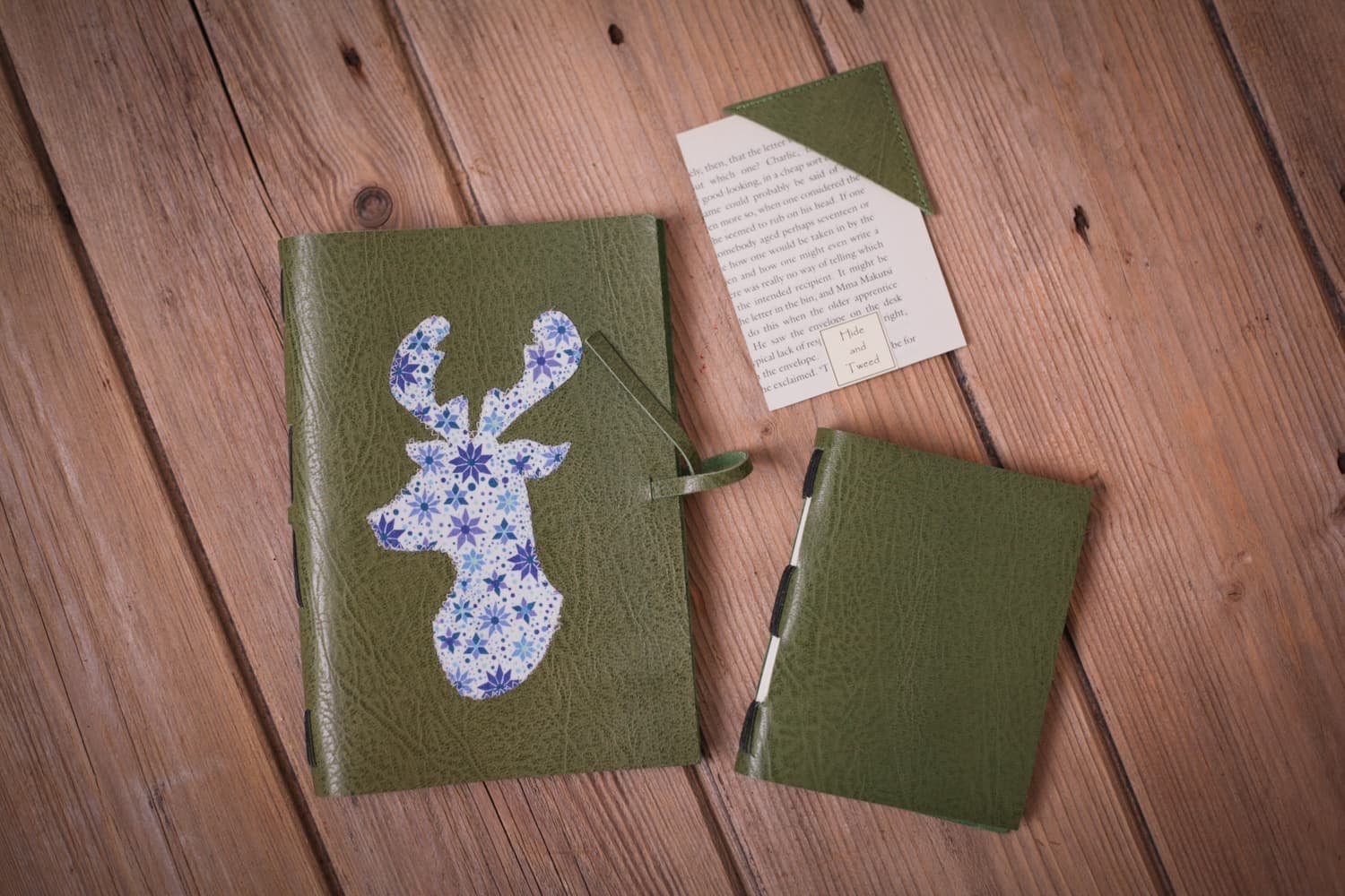 A handmade sketchbook photographed on a wooded backdrop