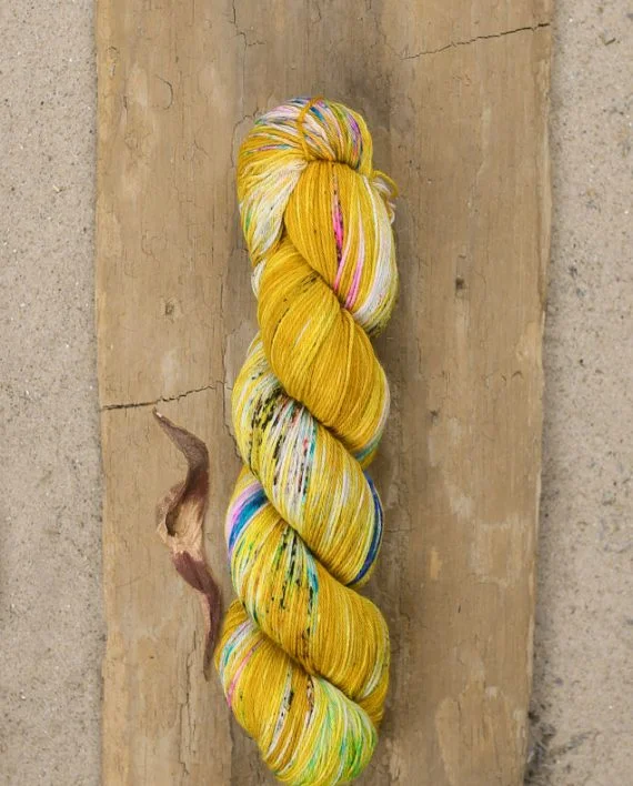 Fool's Gold by Hedgehog Fibres is a forever favorite. The first time I saw it, I knew I wanted every skein in existence. It's so striking & unique, & such a great blend of yellow & other hues! Photo by Wool & Honey .