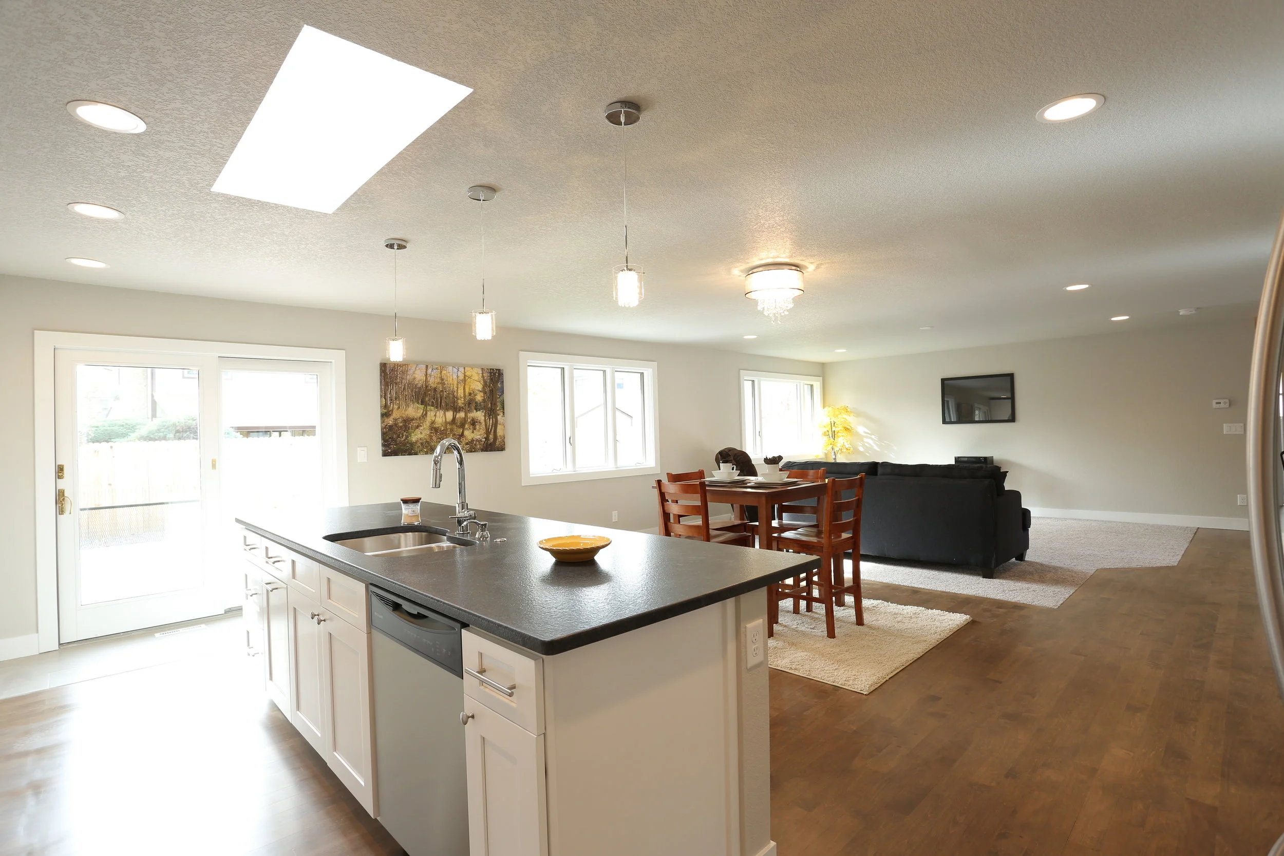 leathered granite counters, stainless appliances, tons of cabinetry and skylight over island