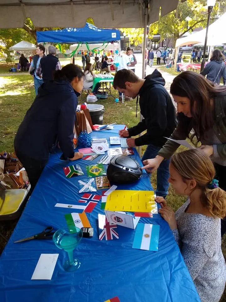 Here you see members of the community engaged at the international club tent at Qaud City