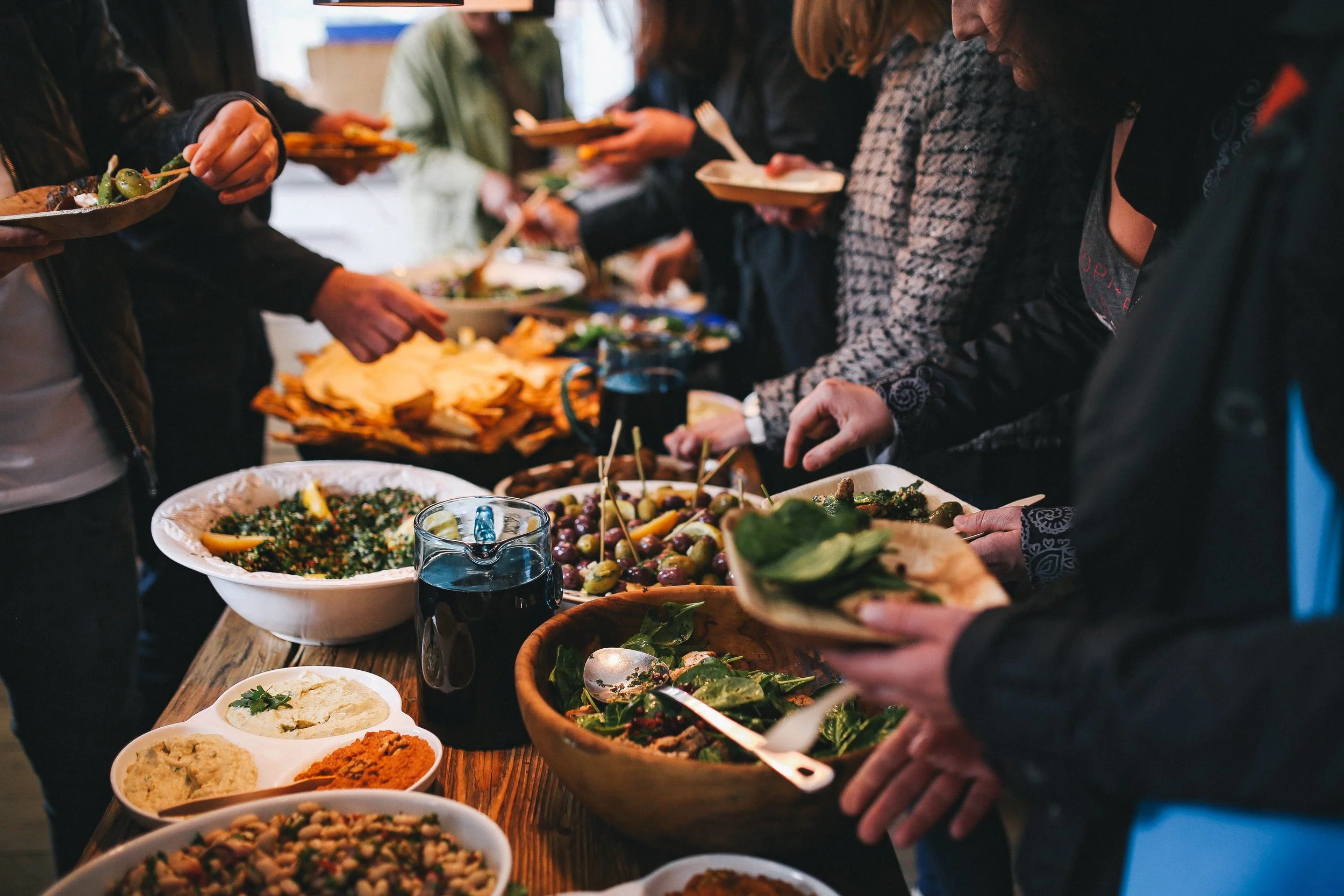 kaboompics_People by a banquet table full with food.jpg