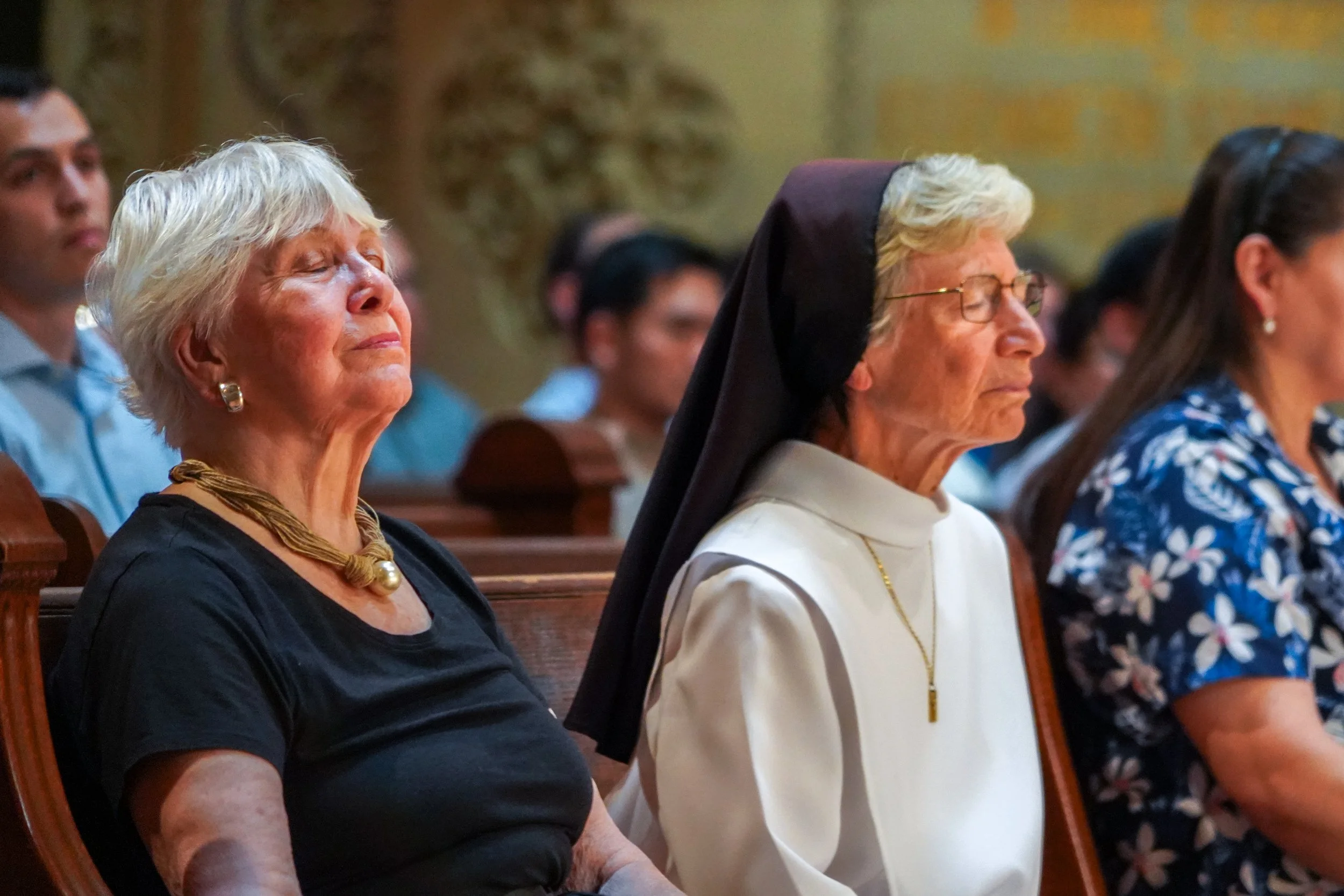 Chaplains Nancy Greenfield and Sister Gloria Marie Jones, OP praying at Mass