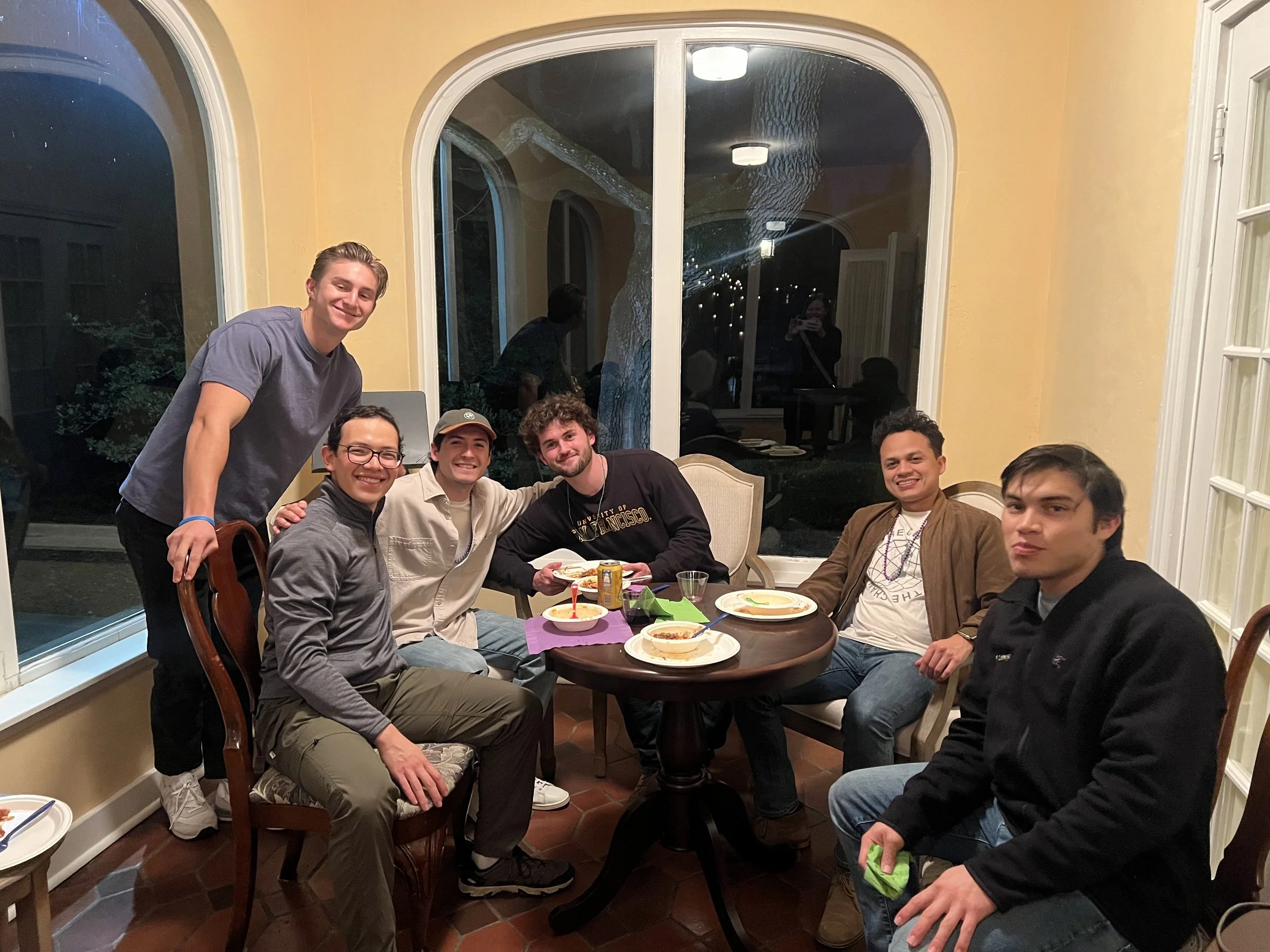 Grad students enjoying the Mardi Gras party at Arbor House