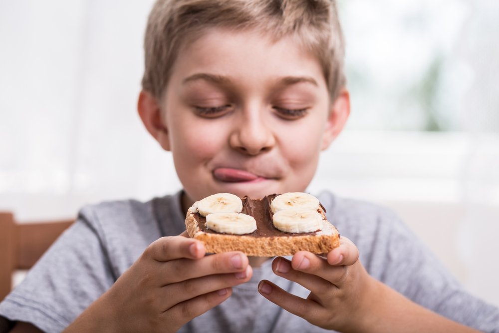 Is your child constantly asking for food? Check out these tips to help your child feel better about food. Boy eating.