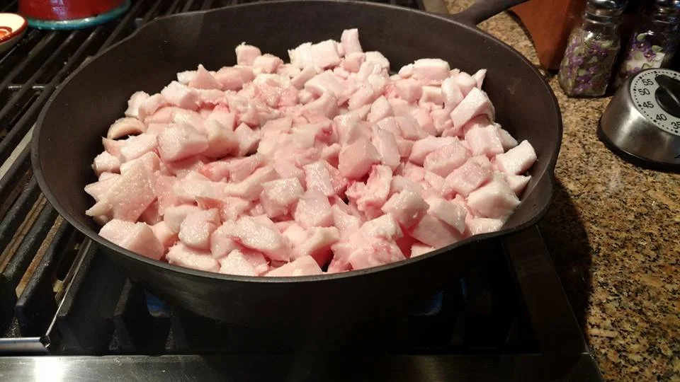 Place the cast iron skillet on your stovetop on medium heat. As the skillet heats, the cubes of fat will begin to release liquid oil — lard!