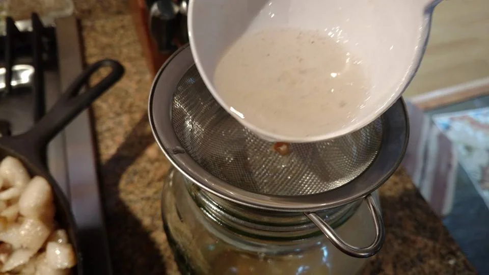 Using a fine mesh sieve, very carefully strain the rendered lard into a heat-proof glass container. Do not use plastic! It will melt!