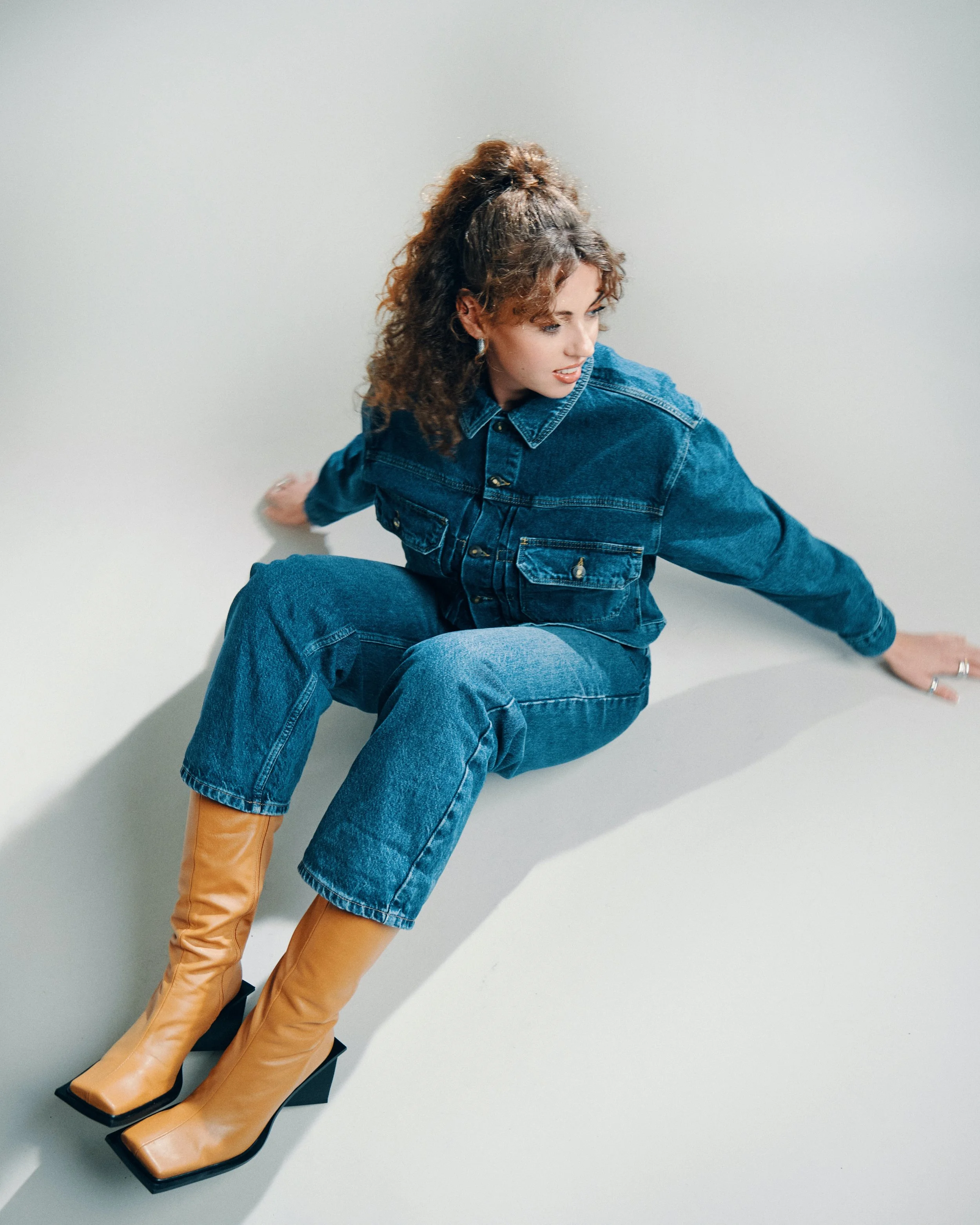 Woman in jean coat sitting on steps