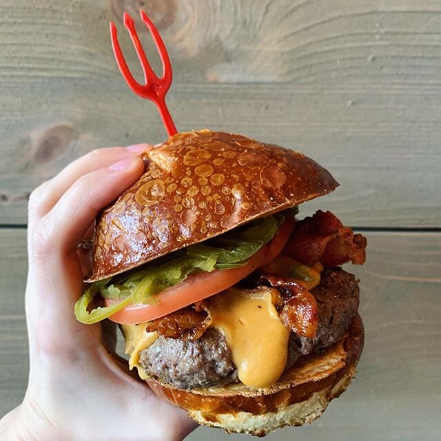 Open for DINE-IN noon to 9 PM 🙌 #HelluvaBurger + #HeavenlyShakes 📷: The Triple B - All Natural Montana Range Bison slathered with Beer Cheese, Applewood Smoked Bacon, Tomato &amp; Pickled Jalapeños on a Pretzel Bun.