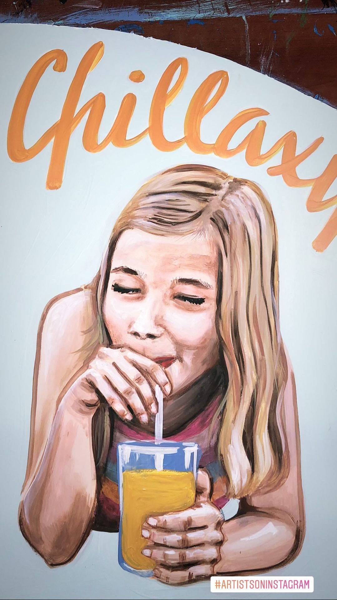 Painting of a young woman with blonde hair drinking orange juice from a glass with a straw, with the word 'chillax' in large orange letters above her.