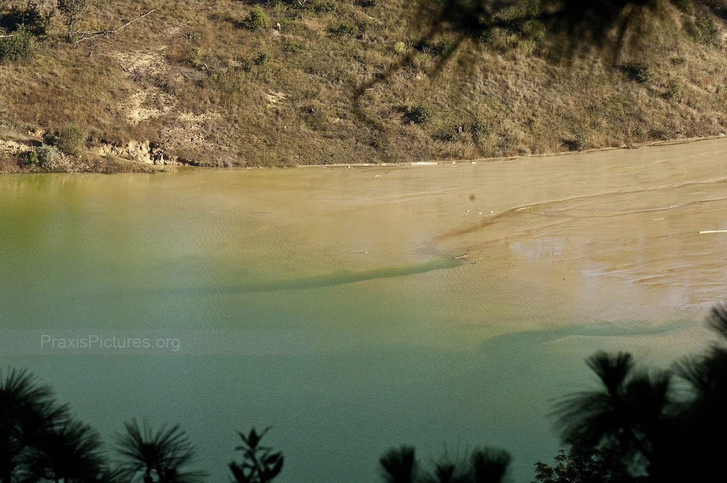 WATER - Like most large-scale gold mines, the extracted ore is processed using cyanide. The remaining waste material is then dumped in a tailings pond. Locals are very concerned about how the mine may be effecting both the quantity and the quality of their water supplies. The mine uses as much as 250,000 liters of water every hour of every day, which is roughly equivalent to what a Guatemalan family of 8 would use over the course of 25 years. Six to eight wells are reported to have dried up recently, although the company claims it obtains all its water either from what is recycled from the tailings pond or from deep underground sources which are not connected to the communities’ wells. Additional concerns include the possibility of the chemicals leaking out into the rivers or, even worse, that the dyke keeping all the waste in the pond may not be able to withstand the frequent earthquakes in the area. “This worries us,” says Victor, “because the tailings pond is above and we are here below it!”