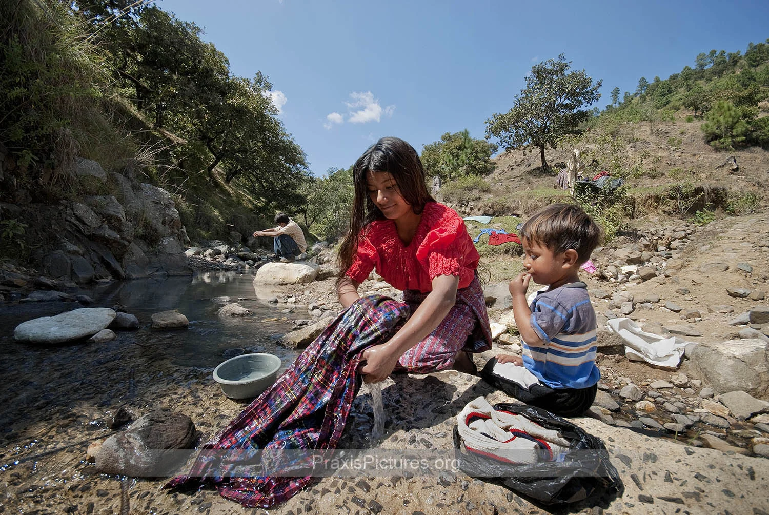 REYNA & ALEX - “They told us the water is fine,” says Reyna as she does her laundry in the river with her brother Alex. “We don’t have any water at the house and our well has dried up, so we have to come down here.” Scientific studies by the Pastoral Commission for Peace and Ecology (COPAE), have shown that the rivers below the tailings pond contain arsenic. “All mines contaminate,” says Alejandro from COPAE, “there are no examples of the mining industry not causing contamination anywhere in the world. Our studies demonstrate that the rivers below the mine are contaminated. The water is not suitable for consumption.” Despite the company’s claims that the water is safe, company employees refused when Freddy, one of the auxiliary mayors of San Miguel Ixtahuacán, challenged them to drink or bathe in the water themselves.