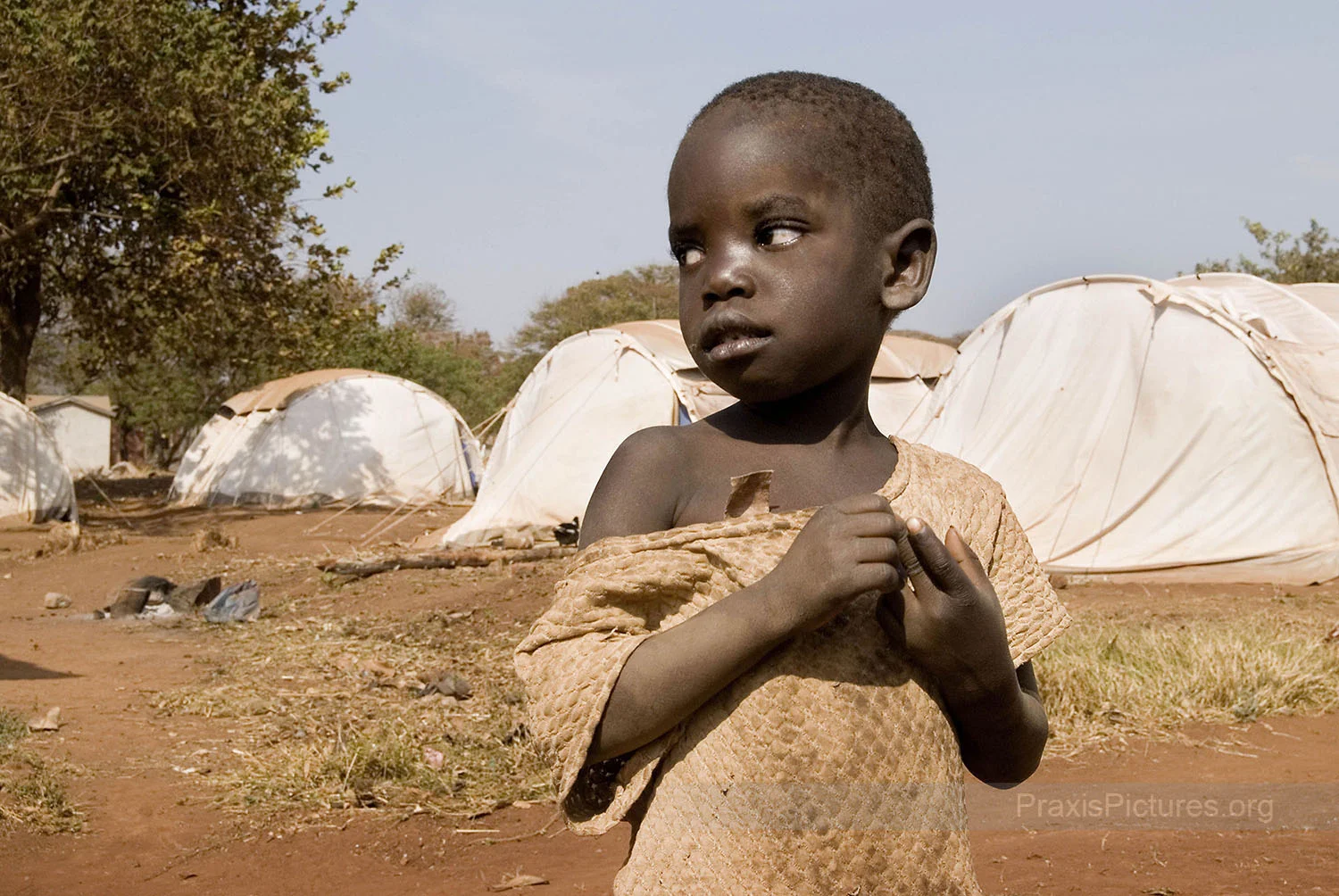 SHEILA FROM MTAKUJA - Sheila is one of 258 men, women, and children, from Mtakuja village who were displaced in late July 2007 to make way for an expansion of the Geita Gold Mine. “We were invaded by administration police officers in the middle of the night, who shoved us out of our houses. We were not given even a chance to take our belongings,” laments Abdallah Abedi, a former village executive officer, “we were moved here like people in a war-torn country, and now we are all tucked into a small place like prisoners who have committed the worst of crimes.” One week after this photo was taken the villagers were informed by the local government that they would be evicted all over again from their current campsite. No provisions have been made for them, however, and they have nowhere to go.