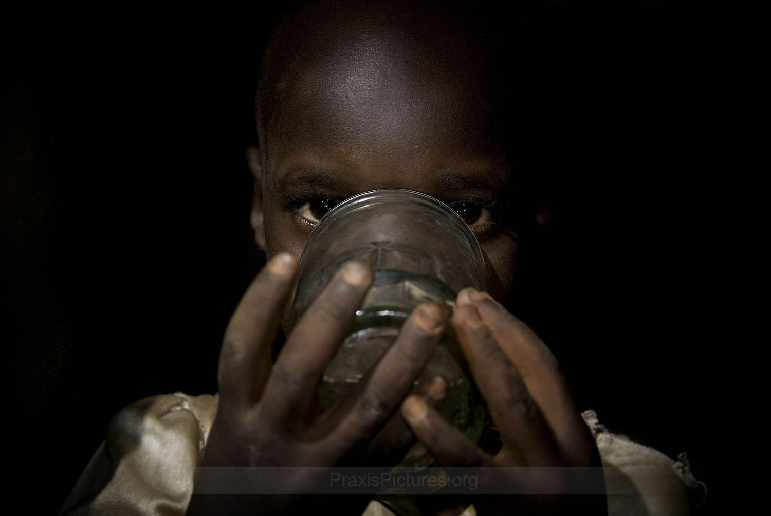 WATER - Mabibhi’s granddaughter drinking the water which residents believe has been contaminated. residents report that the water now tastes bitter and smells foul AngloGold claims that they carry out “regular monitoring around the village” and their results do not coincide with the conclusions of Bitala’s study. They point out that any problems may in fact be stemming from the old mine in the same location operated by Germany in colonial times. Human rights lawyer Tundu Lissu argues that “the description of the deaths and other health problems reported by the villagers of Nyakabale are consistent with the symptoms associated with cyanide poisoning.”