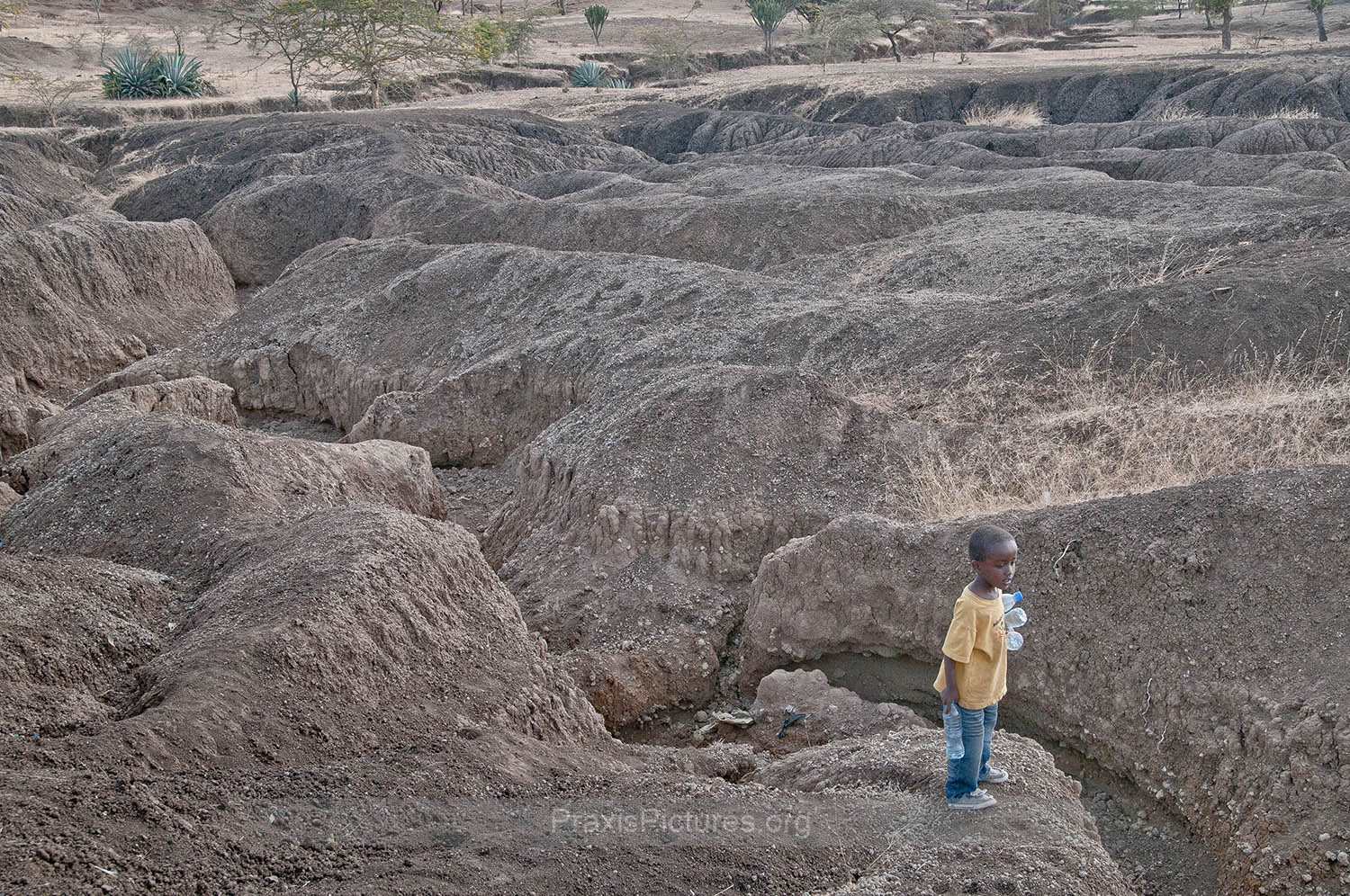 SOIL EROSION - The parched earth has altered the landscape surrounding Ngorbob. Once green fields have eroded leaving the area dangerous for the local children like Baraka.