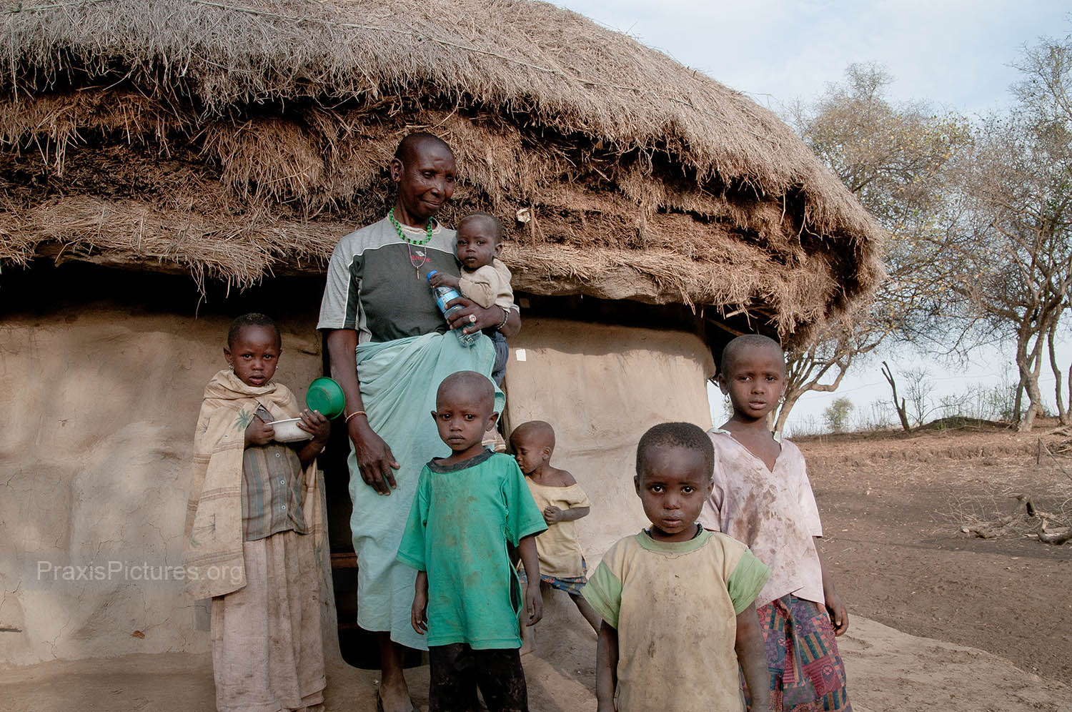 KOKOYA AND GRANDCHILDREN - With the young and able-bodied having to journey farther and farther to find water and employment, the children and elderly are left behind in the village.