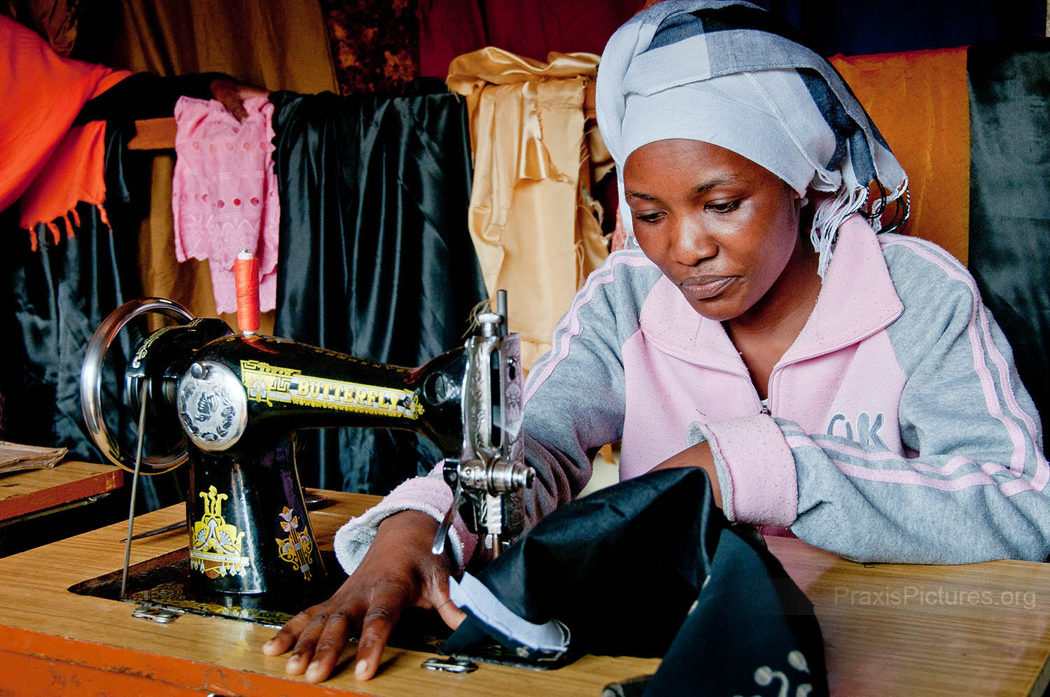 ZUENA - Zuena joined a local VICOBA group in 2007 and took out some loans to invest in her tailor shop. This investment has paid off for her as her business has grown and she now employs four of her neighbors.