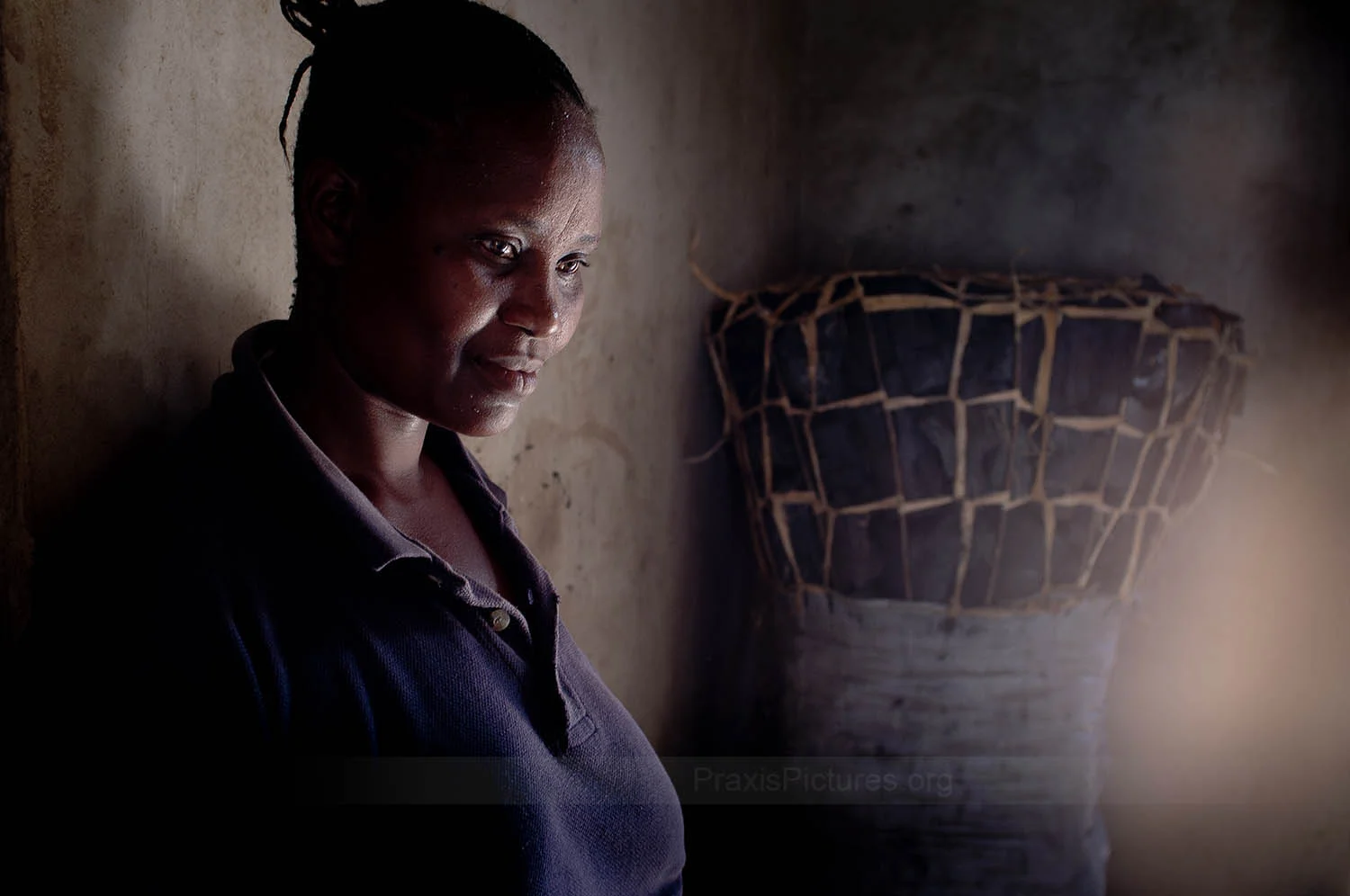 PRISCA - Prisca sells charcoal in the market in Geita. She used to be a manual laborer so she is much happier now buying and selling charcoal. The work is easier, physically, and earns her more income. With the income from her business, her family has been able to build a home for themselves.